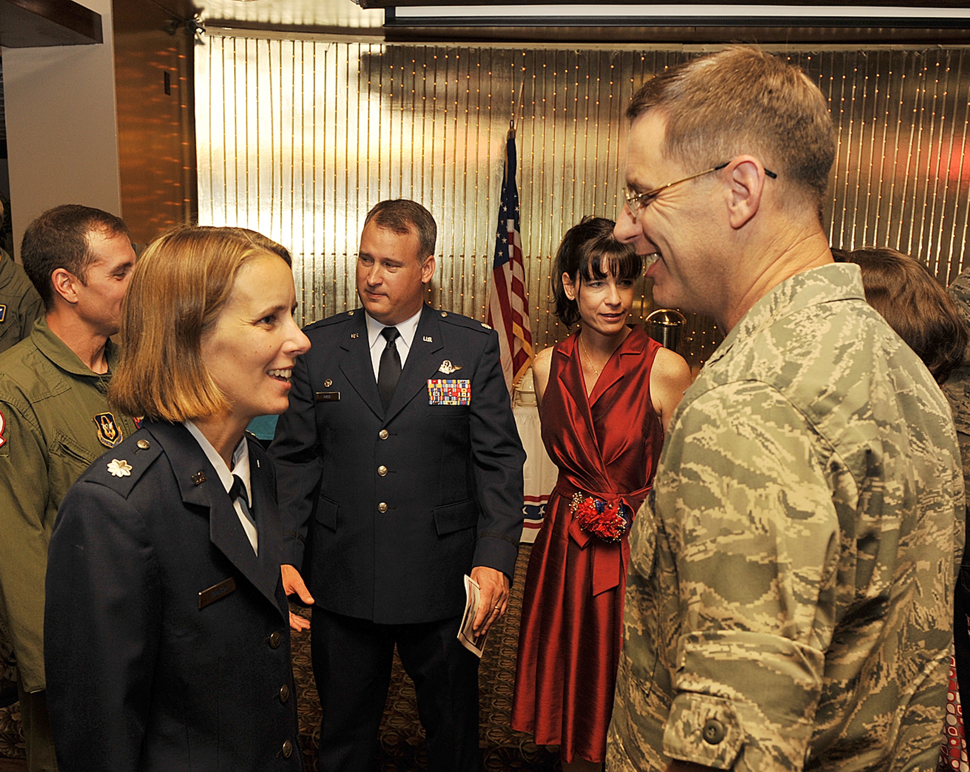 Lt. Col. Jennie Johnson is congratulated by Col. James Van Housen, 302nd Maintenance Group commander, after she assumed command of the 302nd Operations Support Squadron Aug. 8 at Peterson Air Force Base, Colo. Colonel Johnson, an Air Force Reserve senior C-130 Hercules navigator with more than 1,400 flying hours, assumed command of squadron directly after the unit stood up during a unit activation ceremony. The 302nd OSS is charged with supporting operations within the 302nd Airlift Wing, including aircrew life support functions, flying tactics review and intelligence. (U.S. Air Force photo/Larry Hulst)
