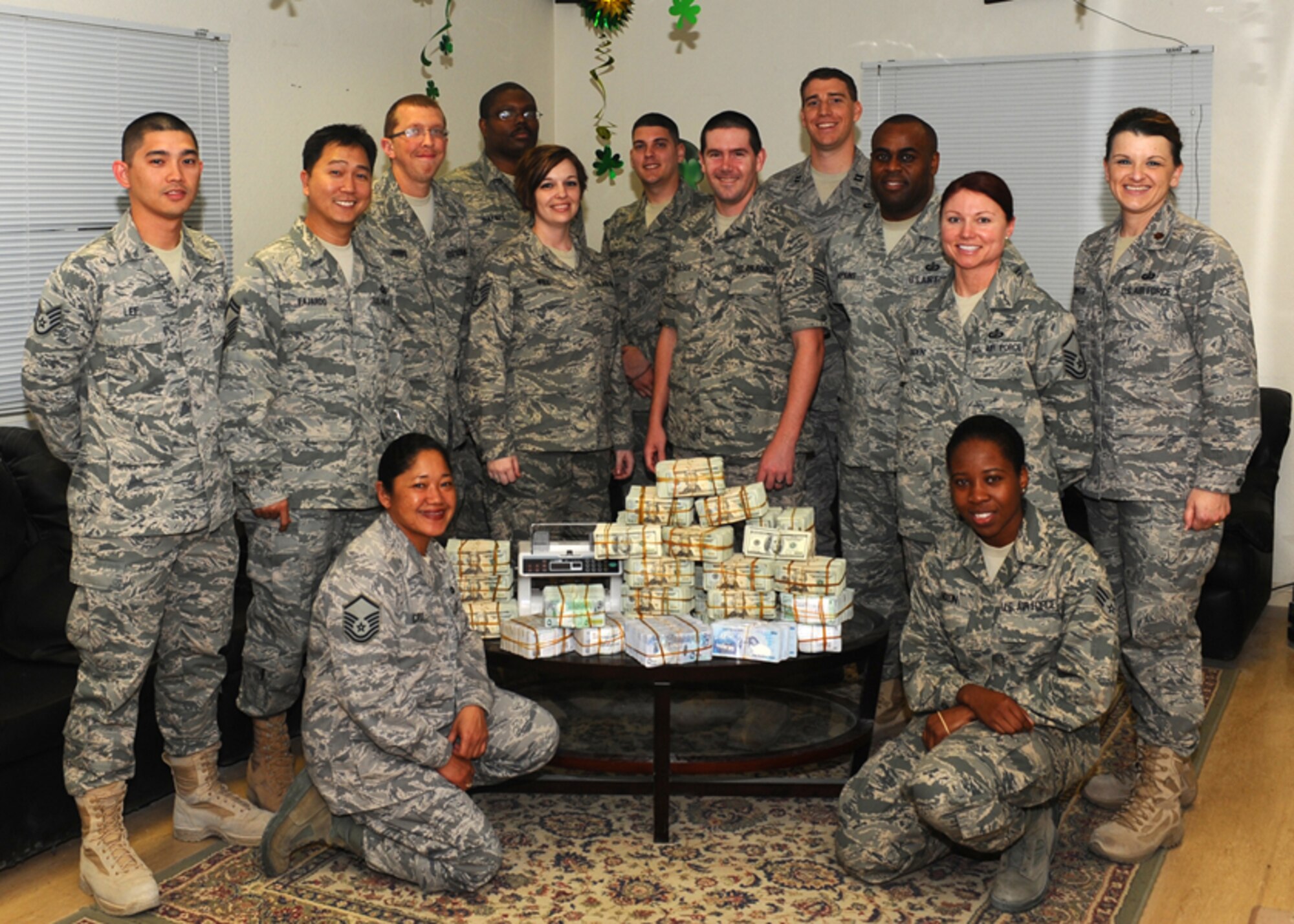 Arnold's first civilian deployer, Joshua Johns, third from the left, poses for a group photo with those he served with.  Pictured (from left to right) are Staff Sgt. Terence Lee, accounting tech; Senior Master Sgt. Armando Fajardo, superintendent; Joshua Johns, budget technician; Tech Sgt. Jason Haynes, budget NCOIC; Staff Sgt. Aleha Will, customer service technician; Senior Airman Steven Colletta, accounting technician; Staff Sgt. Richard Paulsen, Customer Service Technician; Capt. Joshua Weed, budget officer; Tech Sgt. Sterling Hopkins, accounting NCOIC; Master Sgt. Joanna Ogden, paying agent; and Maj. Michelle Griffith, commander. Front Row (kneeling, left to right) is Master Sgt. Lourdes Cruz, customer service NCOIC; and Senior Airman Neisha Nixon, cashier. (Photo provided)