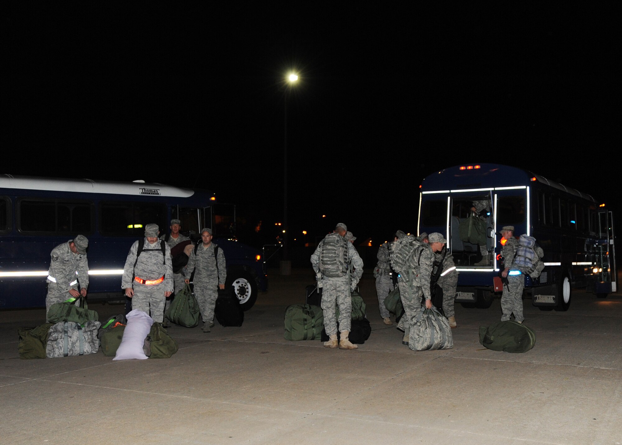 Team McConnell Airmen exit a bus and unload their baggage before proceeding to a “deployment line” while participating in an operational readiness exercise Aug. 16, 2010, McConnell Air Force Base, Kan.  Personnel at McConnell routinely train for a variety of scenarios to gain familiarity and prepare to fly, fight and win. (U.S. Air Force photo/Airman 1st Class Andrea Salazar)