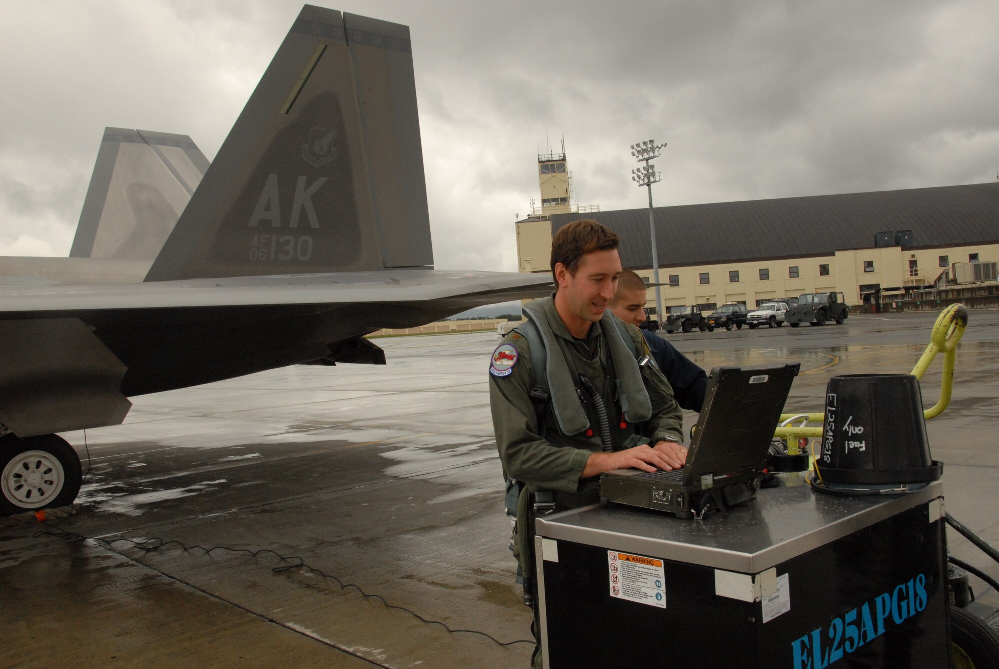 Maj. Chad Feucht, a Reserve F-22 pilot assigned to the 477th Fighter Group, prepares for a sortie during Red Flag Alaska 10-4. In his civilian job Major Feucht is Lockheed-Martin’s lead F-22 mission support software engineer for the 3rd Wing. (U.S. Air Force/Capt. Ashley Conner)