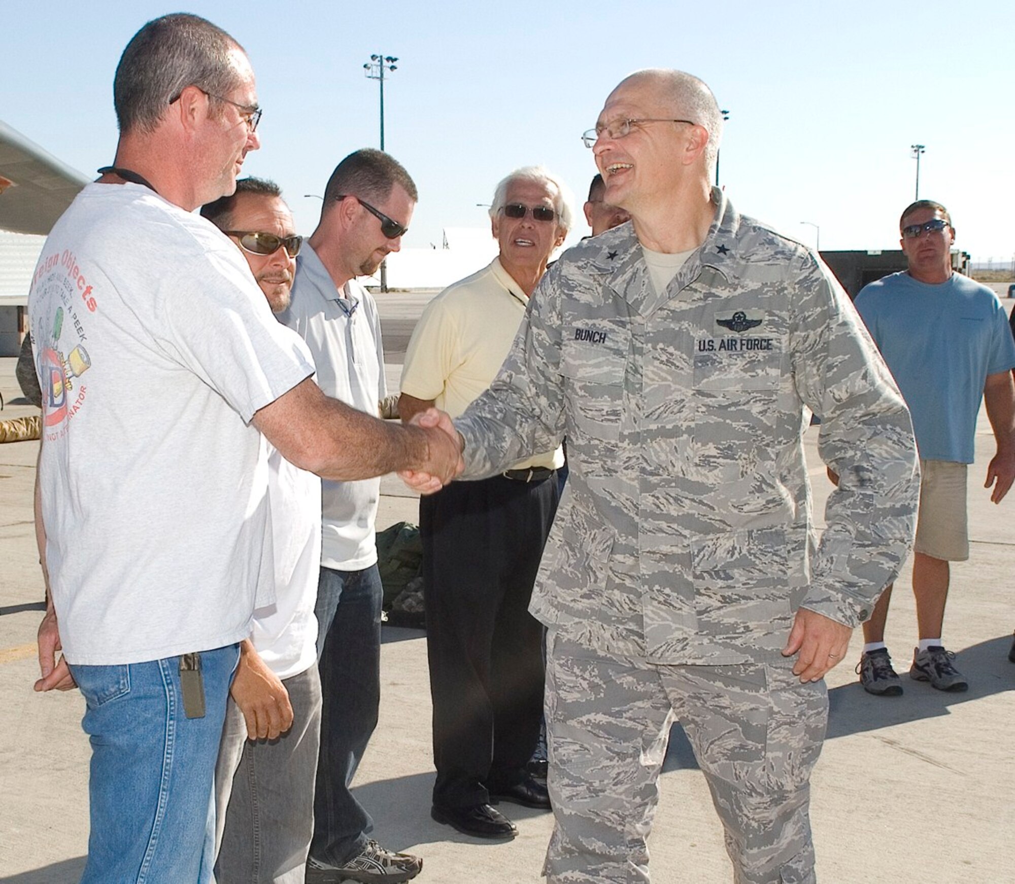 Brig. Gen. Arnold W. Bunch Jr., 312th Aeronautical Systems Wing commander, visits with the 419th Flight Test Squadron workforce Aug. 17. The general dropped by for a few hours to see the bomber test programs here at Edwards. He served as 412th Test Wing commander from January 2006 to May 2008. General Bunch currently serves as the Air Force Program Executive Officer for Fighters and Bombers, Aeronautical Systems Center, at Wright-Patterson Air Force Base, Ohio.  He is responsible for cost, schedule, performance, and life-cycle management of the fighter and bomber attack portfolio. This includes the A-10, B-1, B-52, F-15, F-16, Joint Helmet-Mounted Cueing System and panoramic night vision goggles. This portfolio provides horizontal integration among the weapon systems and performs capability planning for the Global Strike Task Force. He is also responsible for the organization, training, and equipment for the F-35, F-22,and B-2 System Program Offices.
