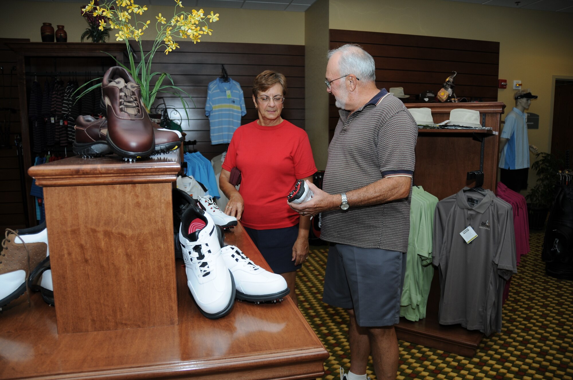 Retirees Joan and Gene Pion of Ocean Springs check out the stock in the new pro shop Friday.  (U.S. Air Force photo by Kemberly Groue)