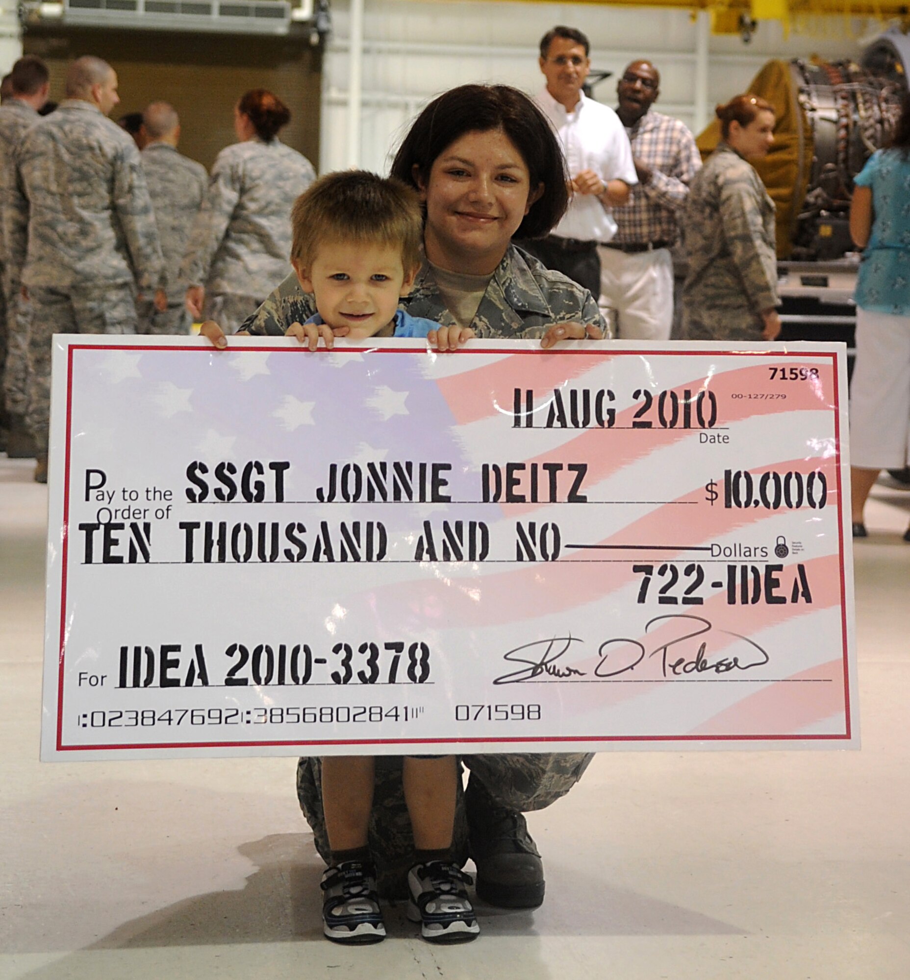 SEYMOUR JOHNSON AIR FORCE BASE, N.C. – Staff Sgt. Jonnie Dietz poses with her son, Brian, 3, after receiving a check for $10,000 from the Air Force Innovative Development Through Employee Awareness Program Aug. 12, 2010. The IDEA Program, awards Airmen with smart proposals that lead to improvements or monetary savings payments based on the merits of their recommendation. Sergeant Deitz is a 4th Component Maintenance Squadron aerospace propulsion journeyman. (U.S. Air Force photo/Senior Airman Makenzie Lang)