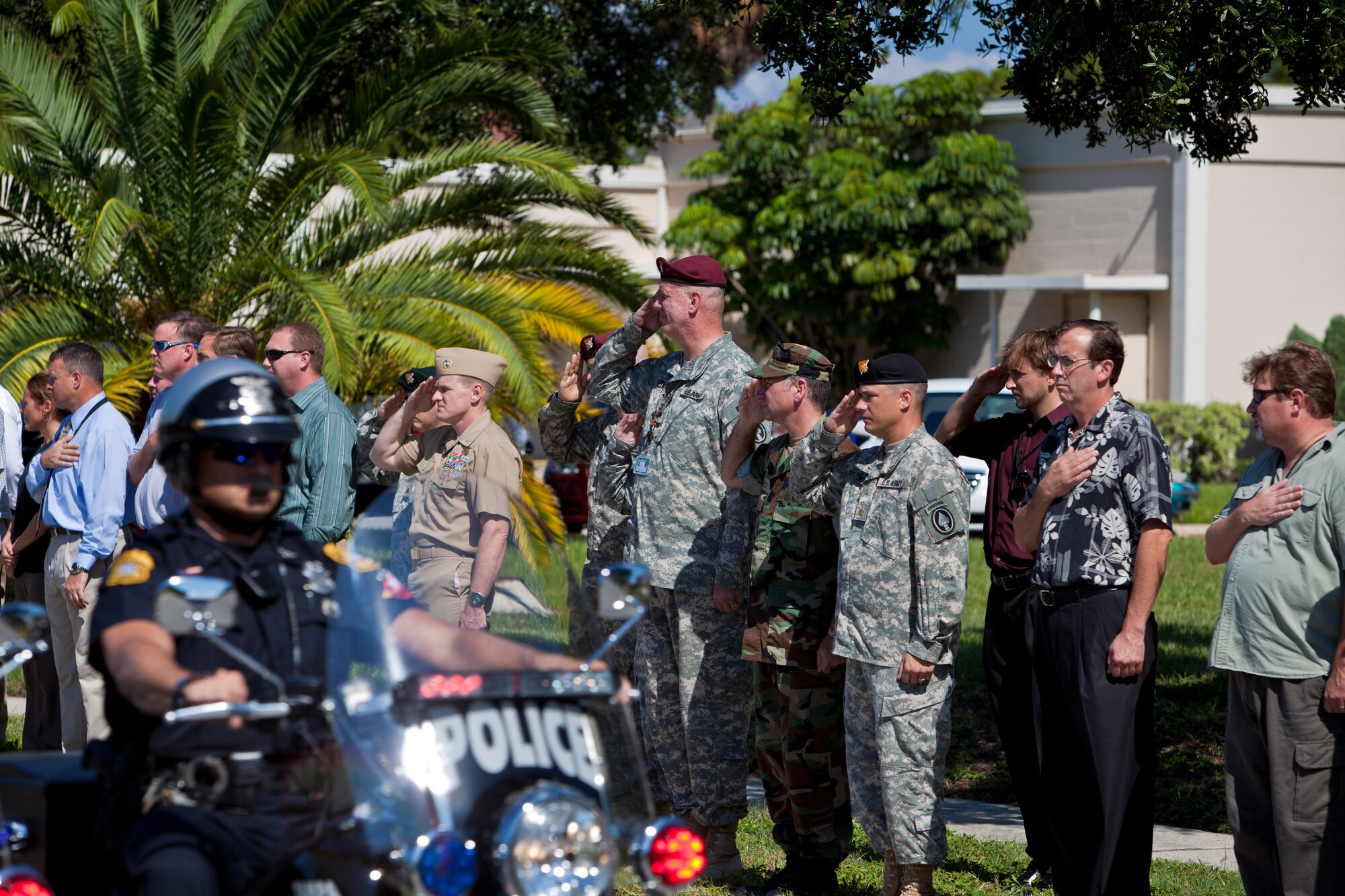 Service members and civilians at MacDill Air Force Base show their respect by saluting or placing their hand over their heart during the precession of fallen solider Private 1st Class Paul O. Cuzzupe II along Florida Keys Avenue, Aug 18, 2010. Private Cuzzupe, 23,  died Aug. 8 in Akhtar-Mohammad-Khan, Afghanistan, of wounds sustained when insurgents attacked his unit using an improvised explosive device.  He was assigned to the 3rd Squadron, 2nd Stryker Calvary Regiment, Vilseck, Germany. (U.S. Air Force photo by: Master Sgt. Mark Borosch)