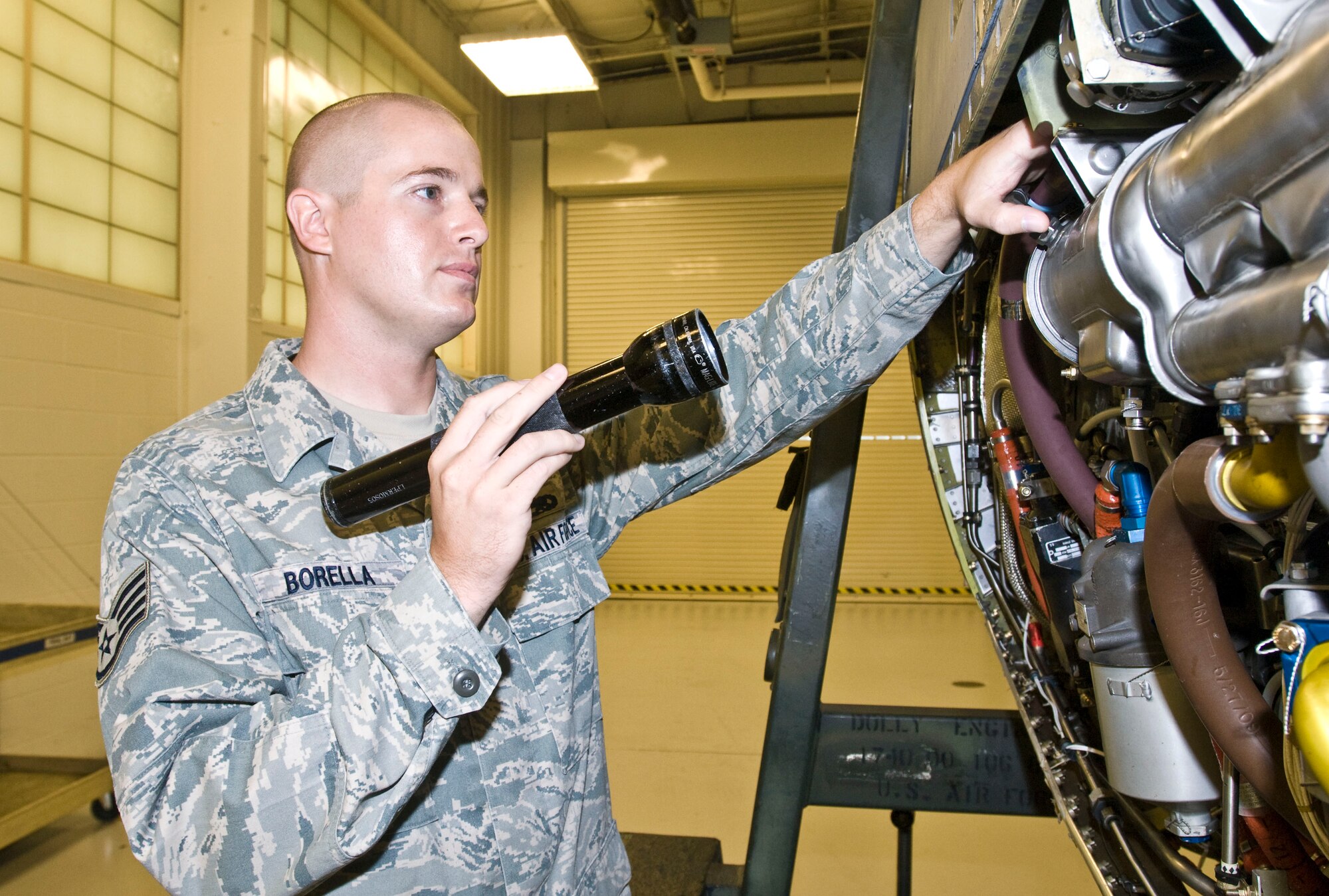 Staff Sgt. Christopher Borella, a 19th Maintenance Group quality assurance inspector, demonstrates what to look for during an engine final inspection Aug. 18 here. The Hayden, Ala. native performed more than 57 evaluations this month and found propeller hub mounting bolts that were incorrectly installed, saving a $385,000 asset. (U.S. Air Force photo by Staff Sgt. Nestor Cruz)