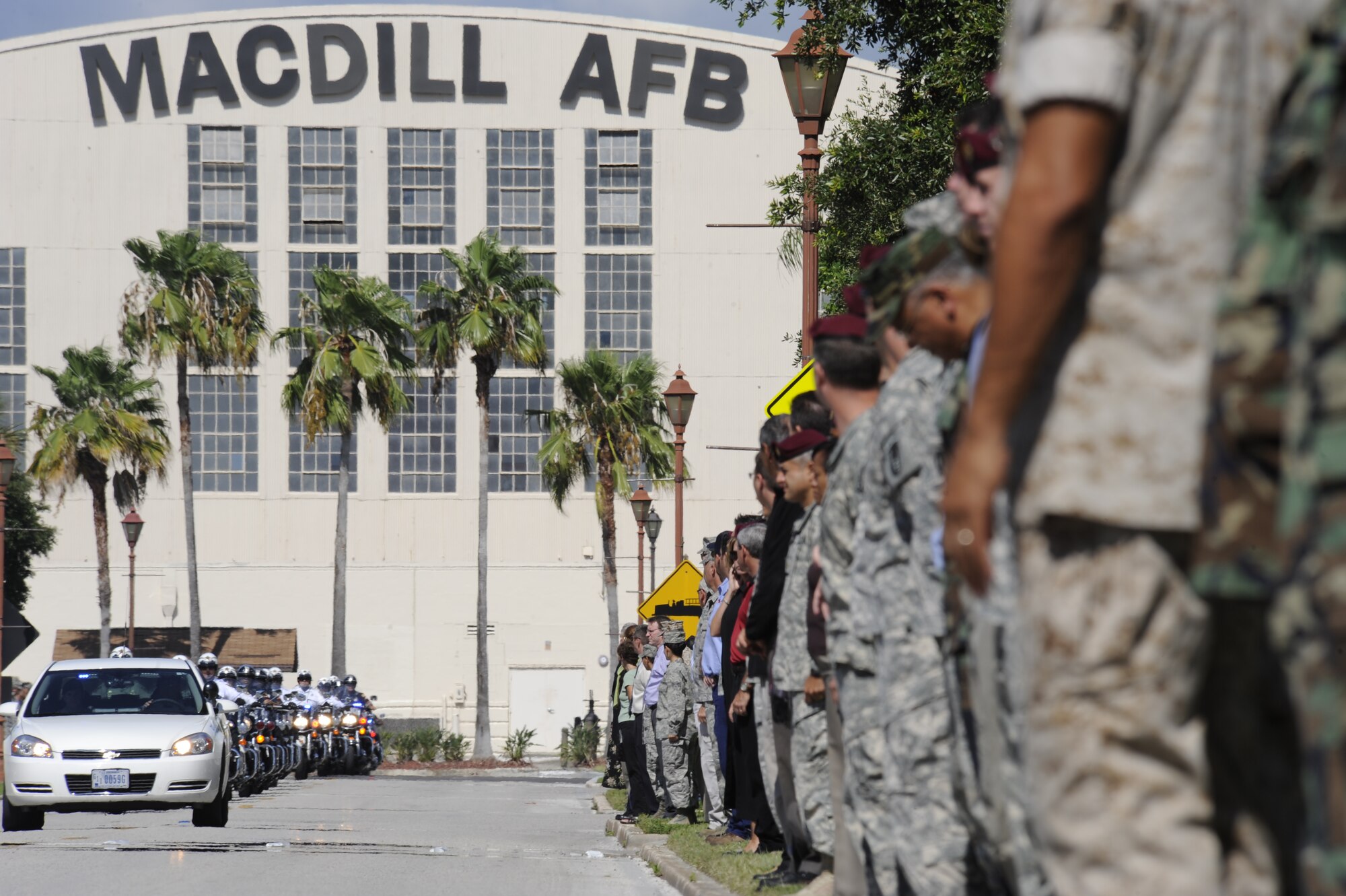 Servicemembers and civilians at MacDill Air Force Base await the precession of fallen solider Private 1st Class Paul O. Cuzzupe II along Florida Keys Avenue, Aug 18, 2010. Private Cuzzupe, 23,  died Aug. 8 in Akhtar-Mohammad-Khan, Afghanistan, of wounds sustained when insurgents attacked his unit using an improvised explosive device.  He was assigned to the 3rd Squadron, 2nd Stryker Calvary Regiment, Vilseck, Germany.(U.S. Air Force photo by: Staff Sgt. Angela Ruiz) 