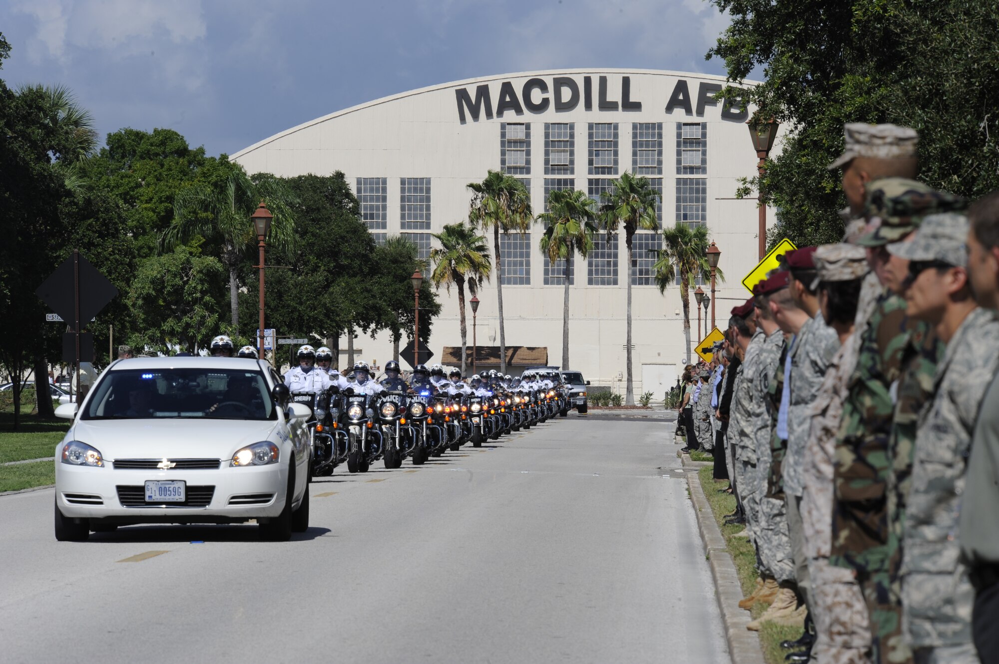 Servicemembers and civilians at MacDill Air Force Base await the precession of fallen solider Private 1st Class Paul O. Cuzzupe II along Florida Keys Avenue, Aug 18, 2010. Private Cuzzupe, 23,  died Aug. 8 in Akhtar-Mohammad-Khan, Afghanistan, of wounds sustained when insurgents attacked his unit using an improvised explosive device.  He was assigned to the 3rd Squadron, 2nd Stryker Calvary Regiment, Vilseck, Germany.(U.S. Air Force photo by: Staff Sgt. Angela Ruiz) 