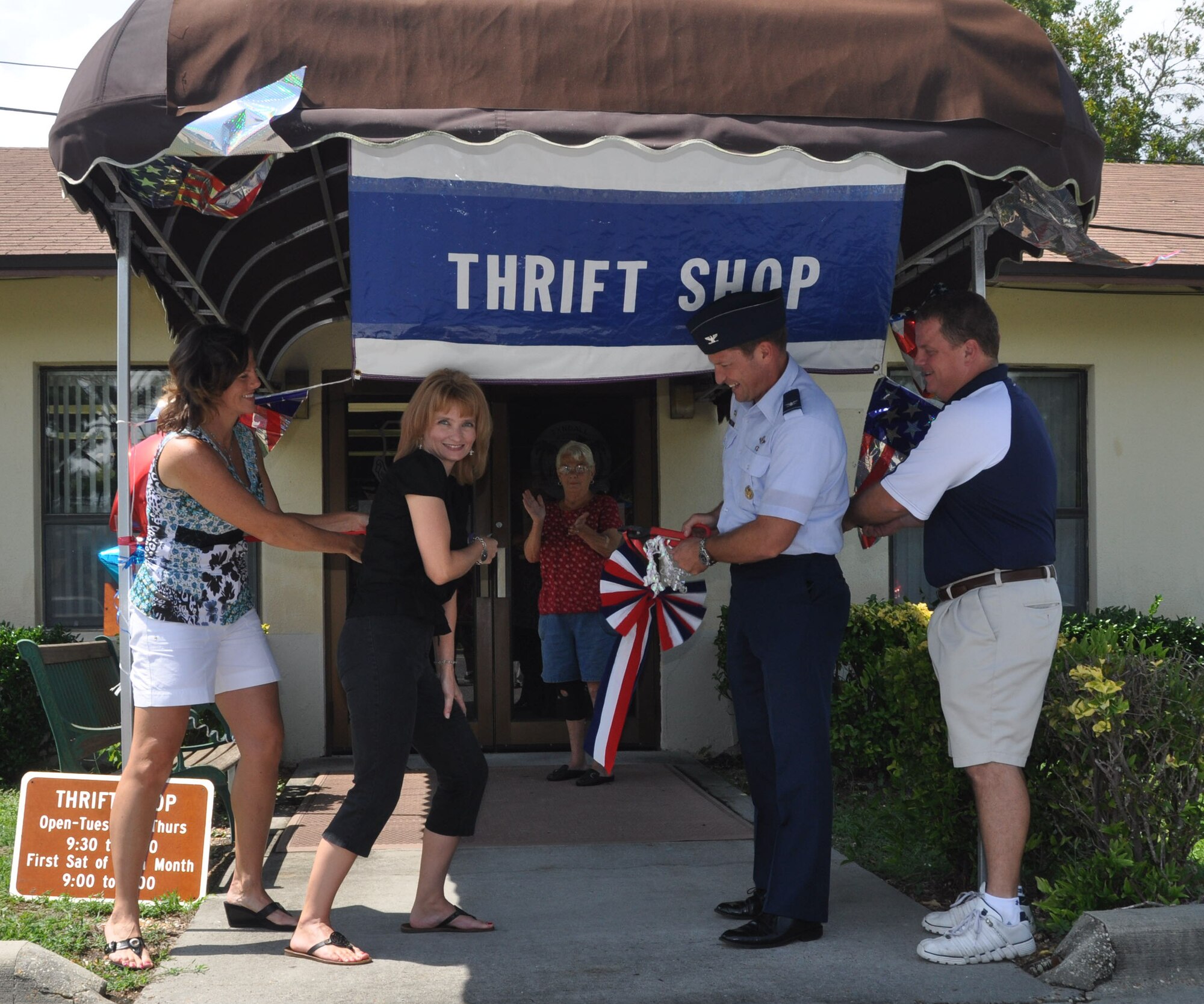 Col. Micheal Fleck, 325th Mission Support Group commander, and members of the Thrift Shop staff, celebrate the re-opening of the Thrift Shop with an official ribbon cutting ceremony Aug. 16 (U.S. Air Force photo by Airman 1st Class Rachelle Elsea)