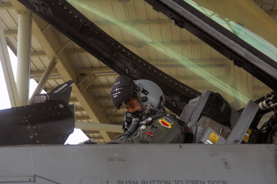 100817-F-6593P-015 SHAW AIR FORCE BASE, S.C. -- Captain David Antonio, 77th Fighter Squadron F-16 pilot, runs through his checklist in the cockpit of his jet before his first deployment in support of Operation Noble Eagle August 17, 2010. ONE provides homeland security and support defending the U.S. from threats and outside and within our borders. (U.S. Air Force photo/Airman 1st Class Daniel Phelps)