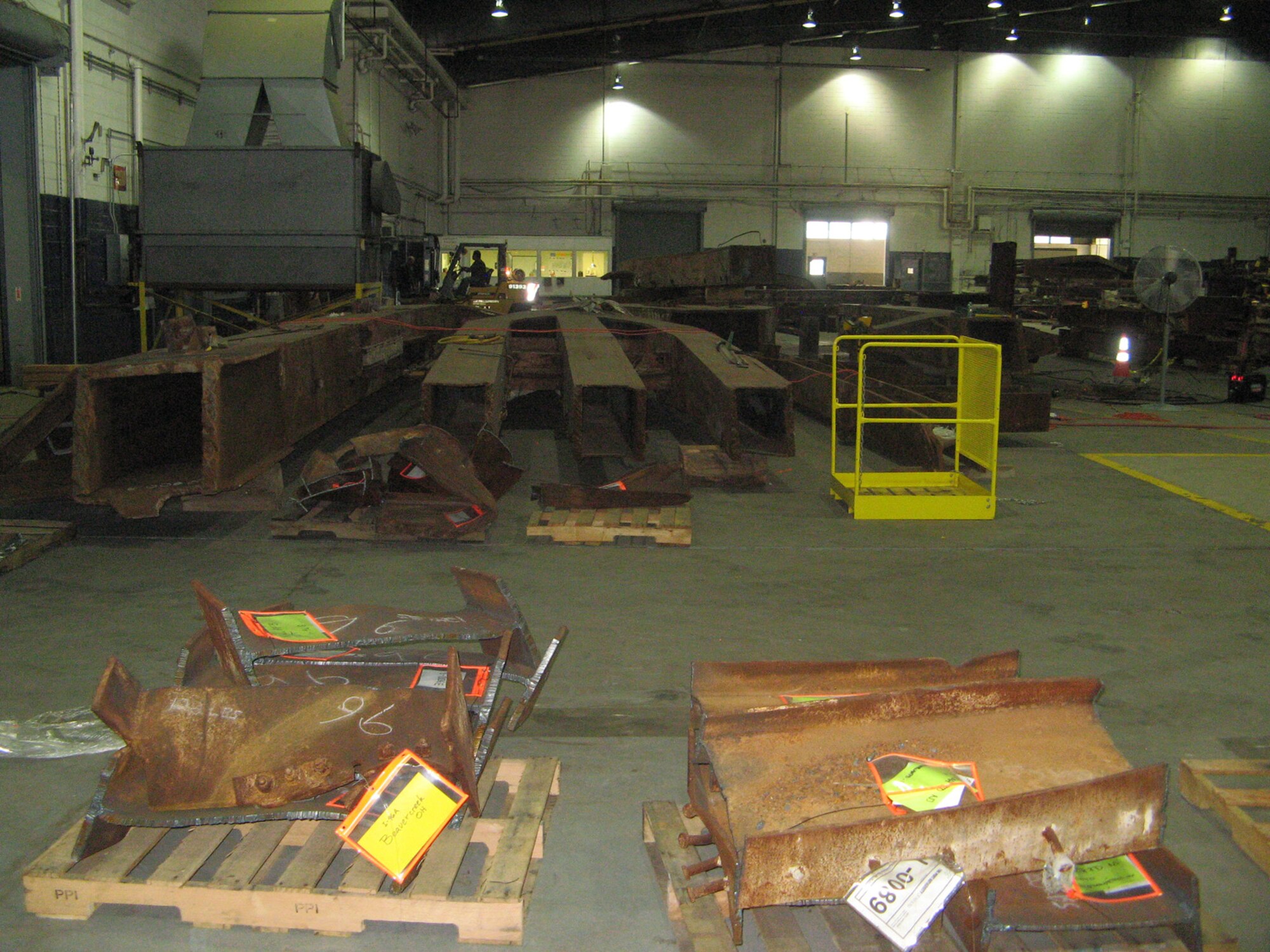 Steel from the World Trade Center stacked in Hanger 17 of the John F. Kennedy International Airport New York, N.Y. The steel is available to those who wish to create a memorial in remembrance of the attacks of Sept. 11, 2001. (U.S. Air Force photo by courtesy photo/Released)
