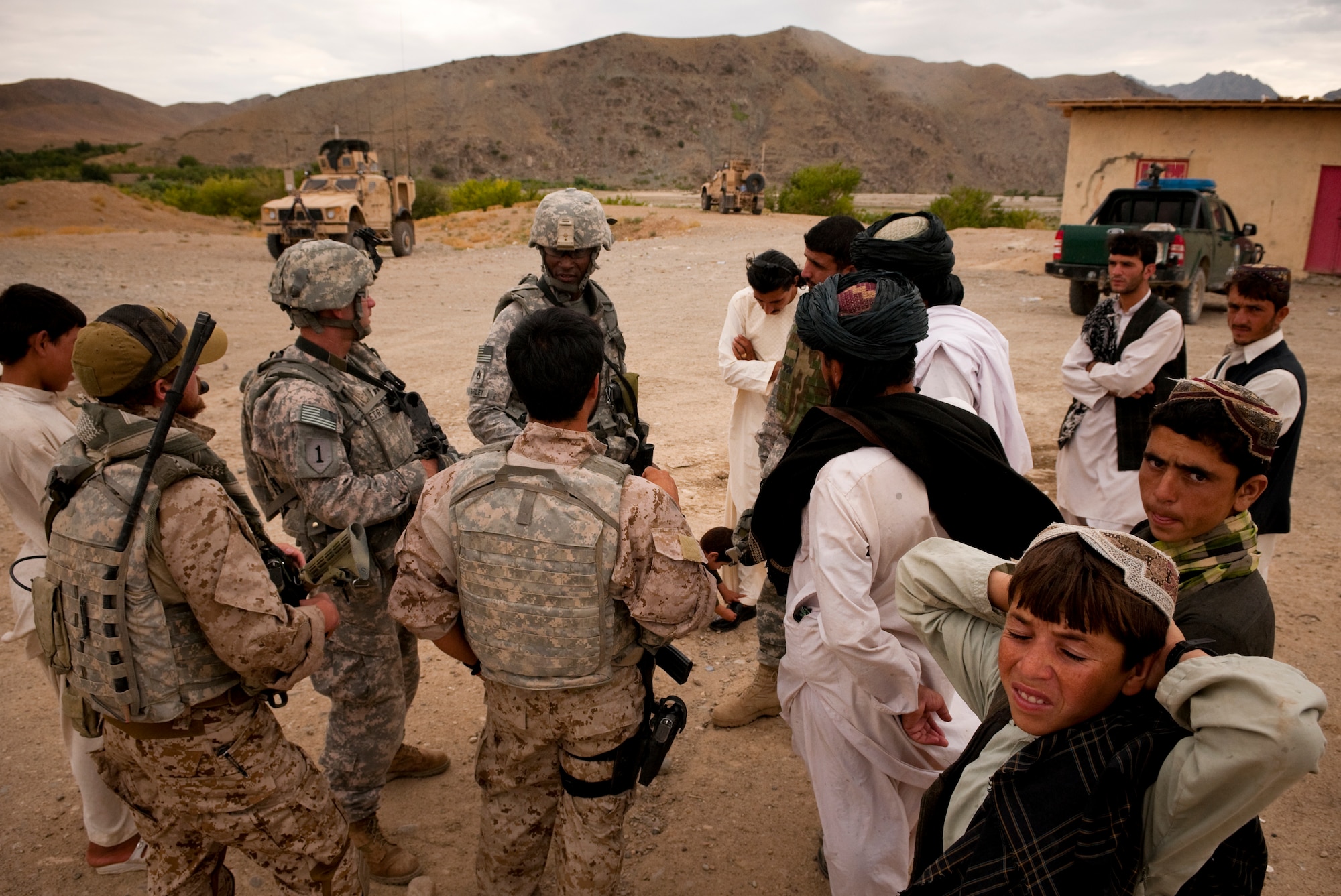 FORWARD OPERATING BASE LANE, Afghanistan -- Members of Charlie Company, 478th Civil Affairs Battalion, and Provincial Reconstruction Team Zabul speak with local shop owners during a meeting near Forward Operating Base Lane, Zabul province, Aug. 5. The teams met to discuss possible improvements to the local bazaar. (U.S. Air Force photo/Senior Airman Nathanael Callon)