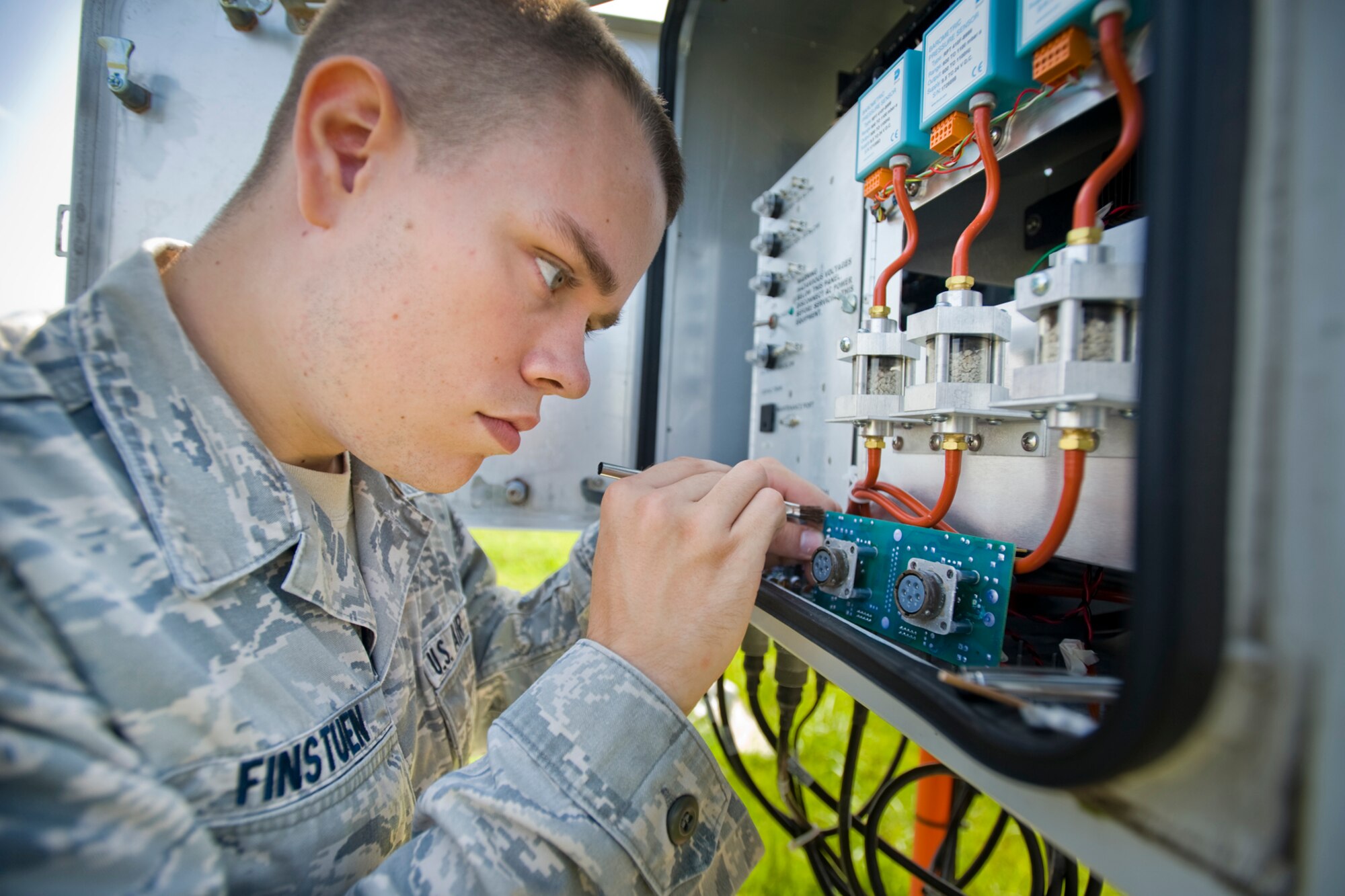 MISAWA AIR BASE, Japan -- Senior Airman Kevin Finstuen, 35th Communications Squadron airfield-systems maintenance technician, conducts a corrosion control check on an automatic observation system Aug. 17 on the flightline. When performing maintenance on the weather system, Airman Finstuen checks for corrosion and any deterioration caused by the elements of nature. (U.S. Air Force photo/Senior Airman Jamal D. Sutter)