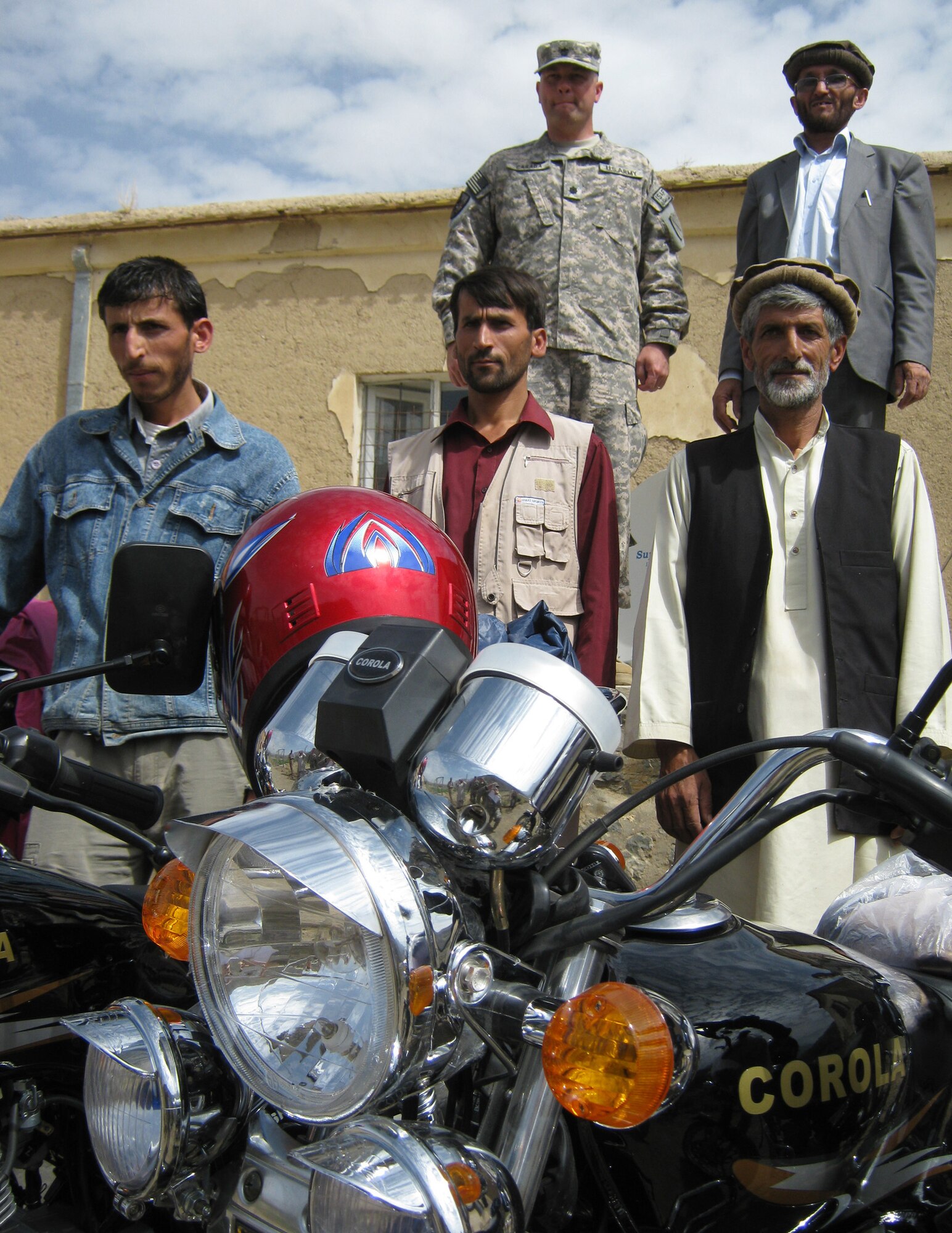 U.S. Army Lt. Col. Jeffrey Casada (back, left), Kentucky National Guard Agribusiness Development Team leader with Provincial Reconstruction Team Panjshir, Abdul Monan (back, right), Panjshir National Environmental Protection Agency director, and three NEPA employees pose in front of brand new motorcycles. On Aug. 17, members of the ADT delivered four Corola motorcycles to the Panjshir Province NEPA. Now, the director says the agency can enforce standards and do the government?s work. (Photo by U.S. Air Force 2nd Lt. Jason Smith, PRT Panjshir Public Affairs)