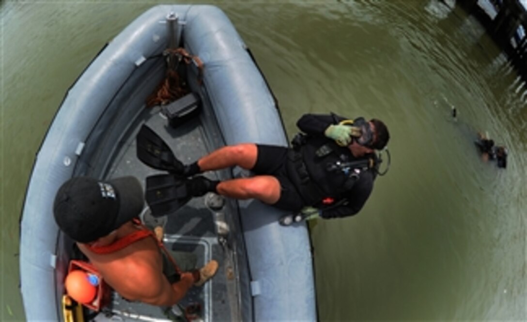 A Peruvian navy diver enters the water during a joint nation underwater survey of a sunken ship in the harbor of Panama City, Panama, on Aug. 16, 2010.  Local port authorities asked for the assistance of Mobile Diving and Salvage Unit 2 to see if the 12-year-old sunken ship could be moved.  Mobile Diving and Salvage Unit 2 is participating in Navy Diver-Southern Partnership Station, a multinational partnership engagement designed to increase interoperability and partner nation capacity through diving operations.  