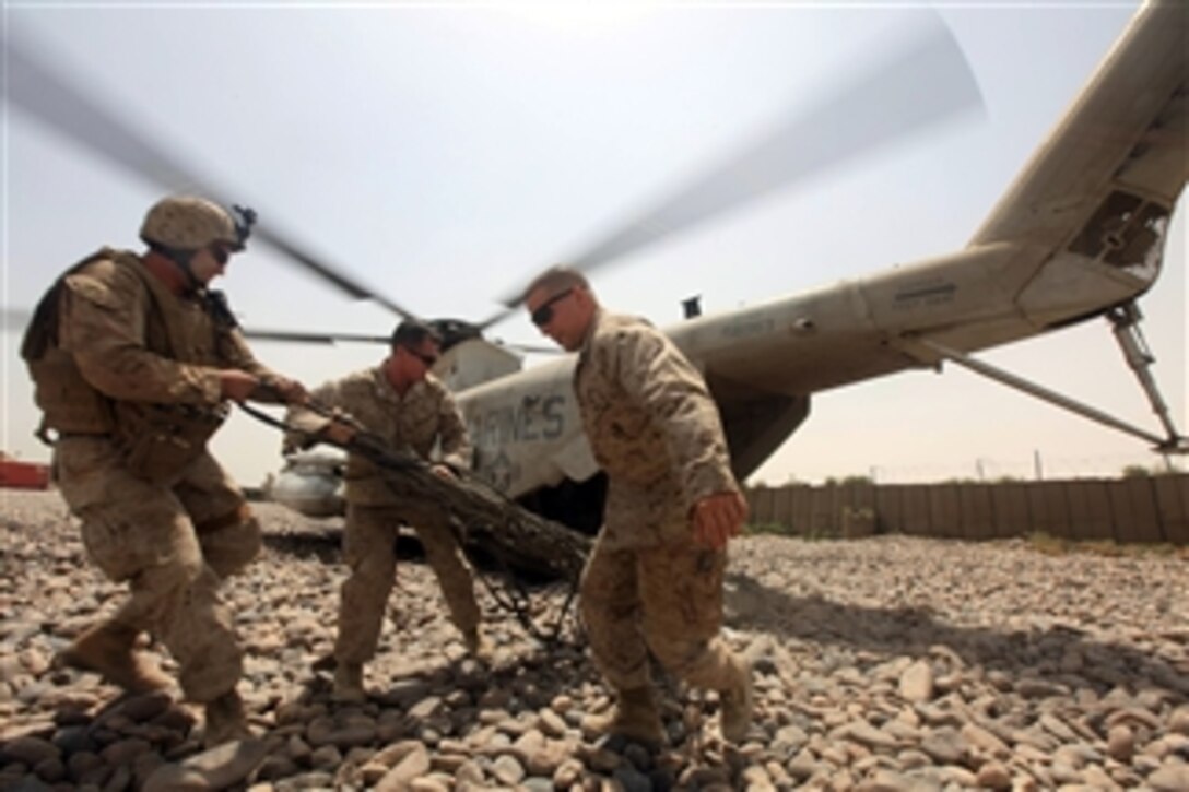 U.S. Marines with Headquarters and Service Company, 3rd Battalion, 1st Marine Regiment, Regimental Combat Team 7 unload cargo nets from a CH-53 Super Stallion helicopter in Helmand province, Afghanistan, on Aug. 12, 2010.  The regiment is deployed to Helmand province to support the International Security Assistance Force.  