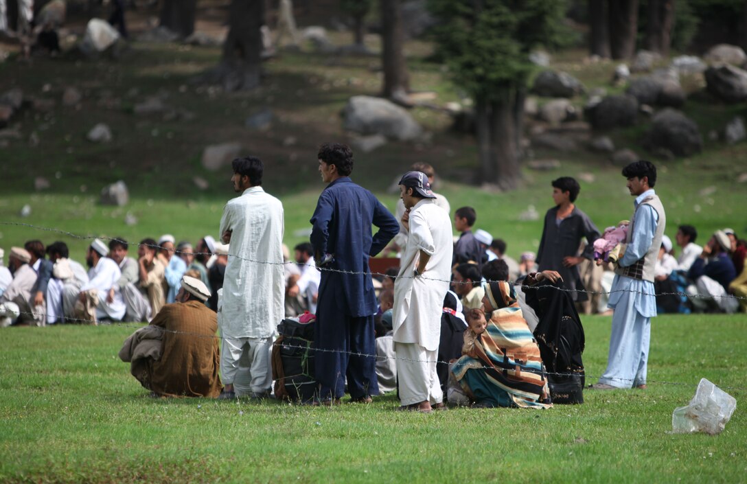 Pakistani civilians wait to board a Marine Corps Super Stallion helicopter during humanitarian relief efforts in the Khyber-Pakhtunkhwa province, Pakistan(formerly known as the Northwest Frontier province, Pakistan).