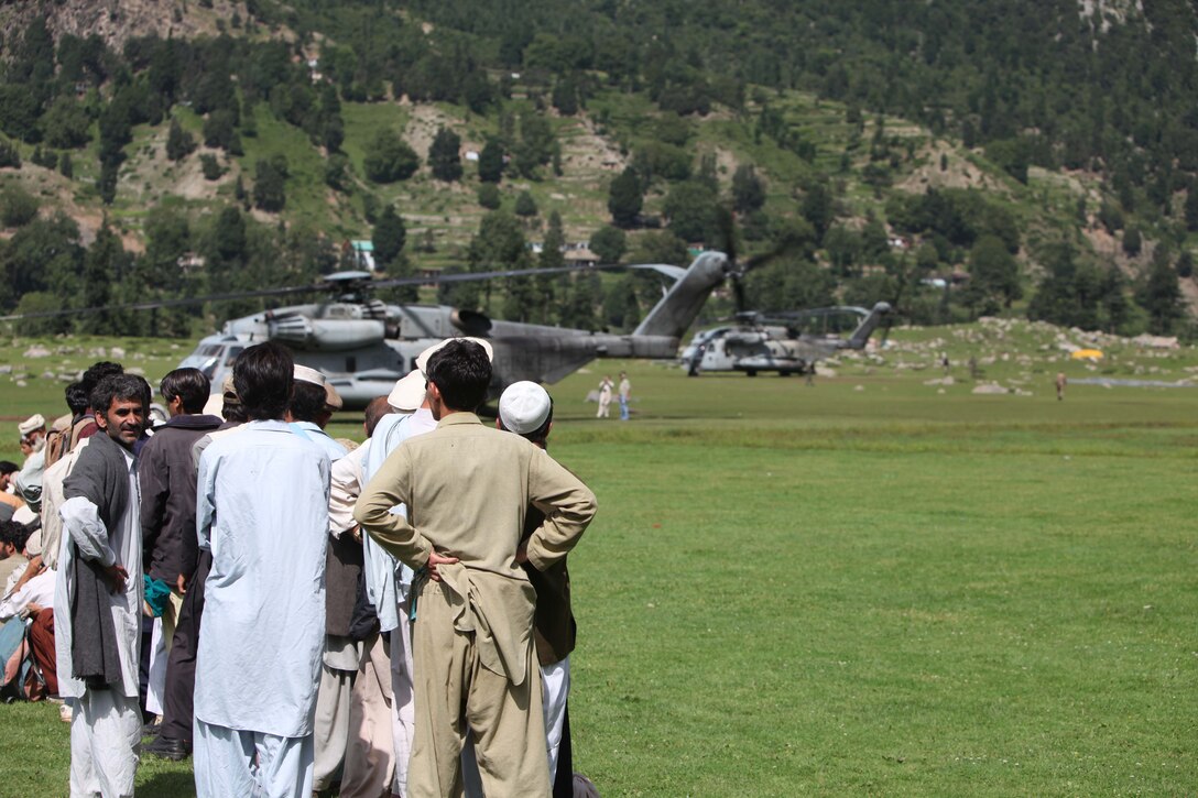 Pakistani civilians wait to board a Marine Corps Super Stallion helicopter during humanitarian relief efforts in the Khyber-Pakhtunkhwa province, Pakistan (formerly known as the Northwest Frontier province, Pakistan).