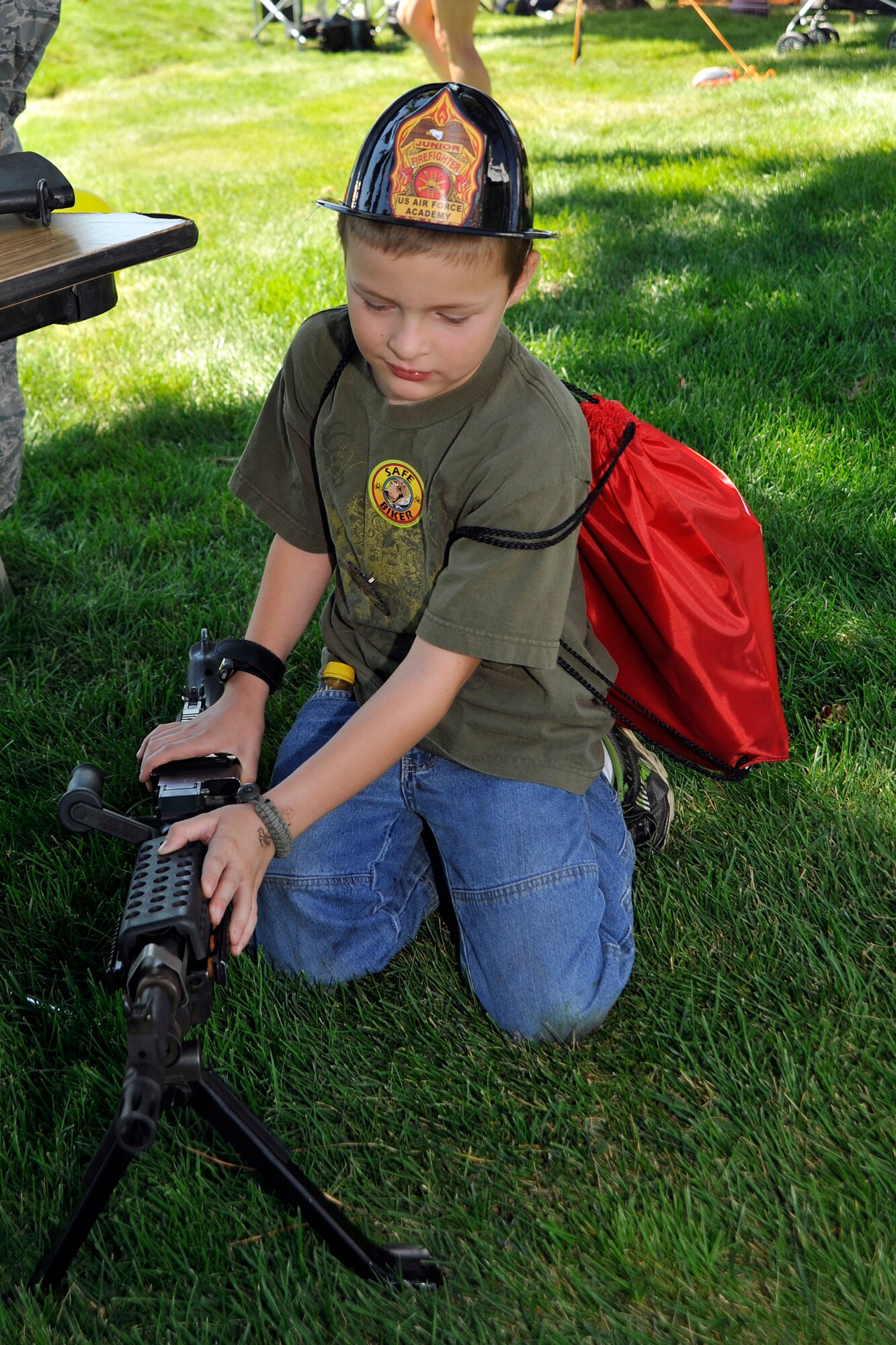 Dakota Sharp checks out a weapons display at the Air Force Academy Fire Department Open House Aug. 14, 2010, at Fire Station 1. (U.S. Air Force photo/Bill Evans)