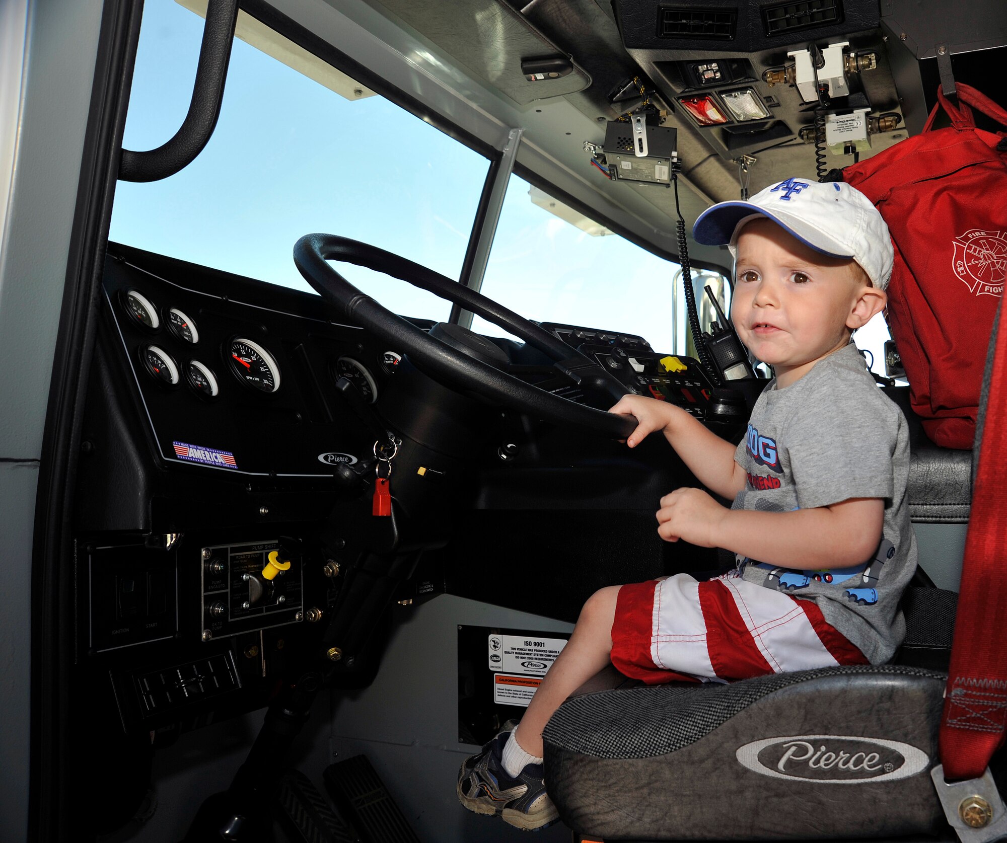 Gabriel Englert sits in the driver's seat of a fire truck on display at the Air Force Academy Fire Department's Open House Aug. 14, 2010, at Fire Station 1. (U.S. Air Force photo/Bill Evans)