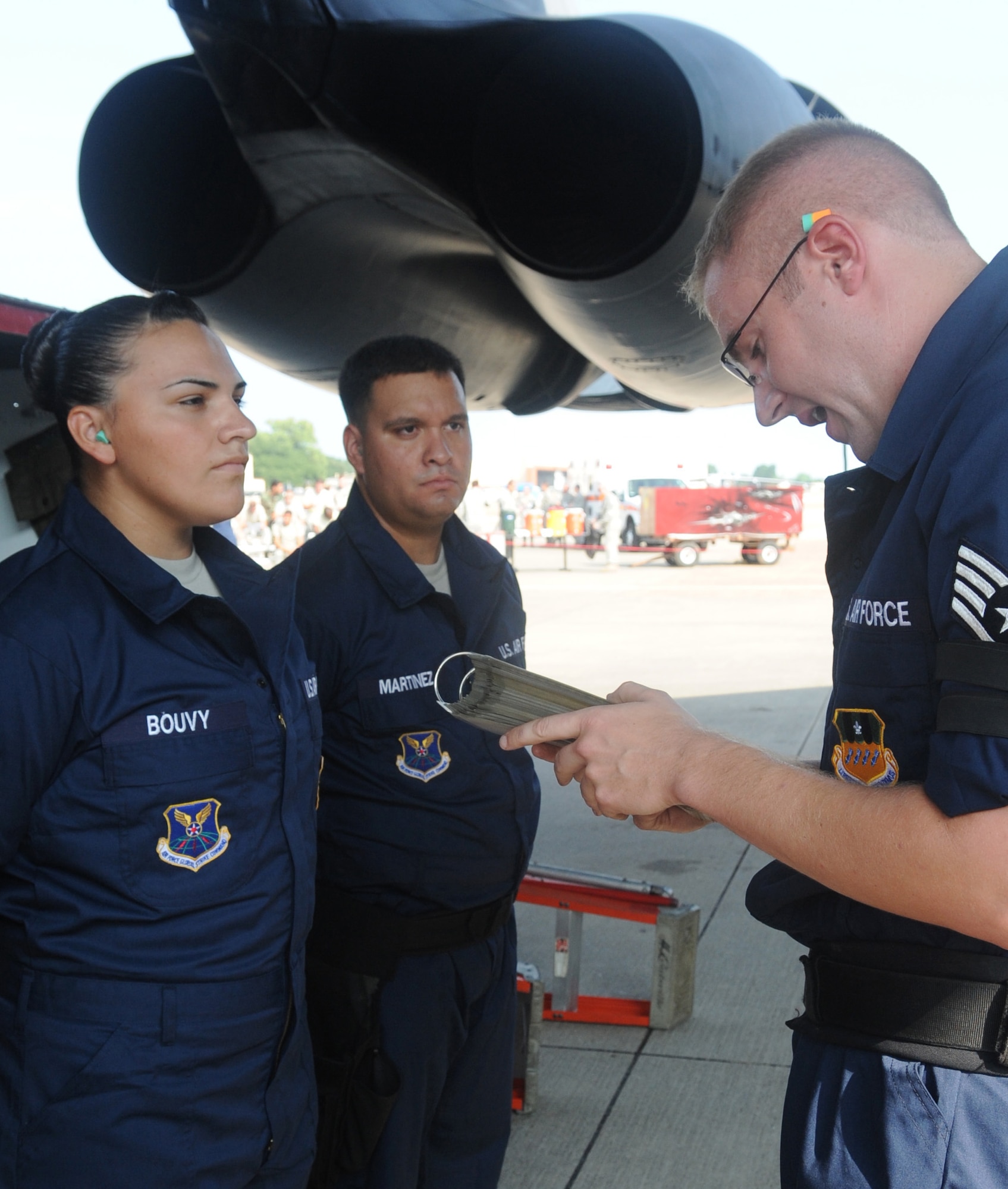 (Left to right) Staff Sgt. Tahnee Bouvy and Senior Airman Francisco Martinez, members of the 2d Aircraft Maintenance Squadron weapons load crew, are briefed by another member, Staff Sgt. Daniel Santell before the weapons load portion of the Global Strike Challenge Aug. 17. More than 400 Airmen from 2d Bomb Wing and B-52 Stratofortress were able to compete in this year?s challenge. (U.S. Air Force photo/Senior Airman Amber Ashcraft) (RELEASED)