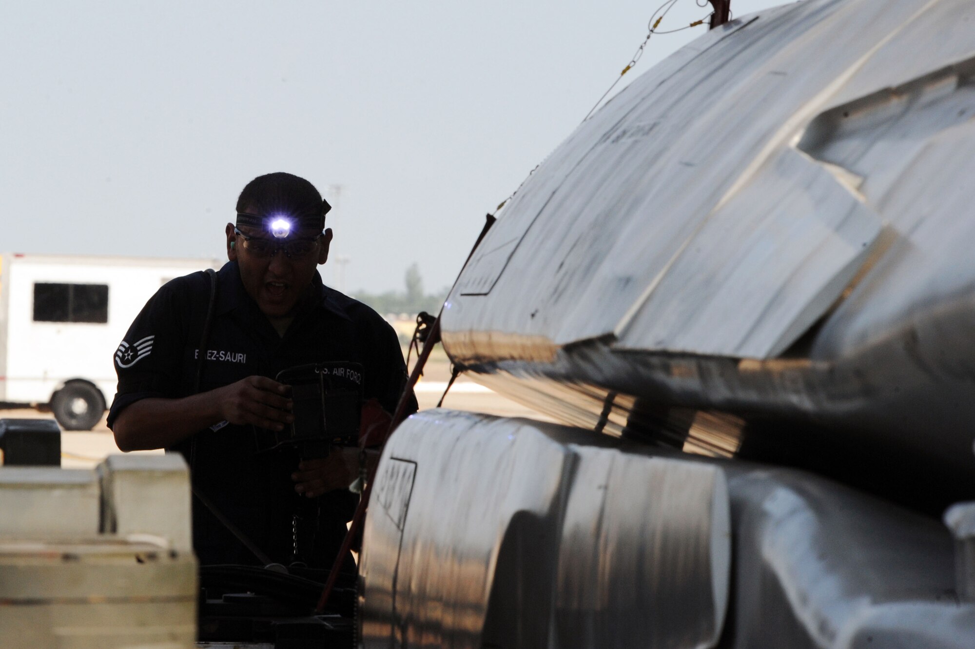 BARKSDALE AIR FORCE BASE, La. - Staff Sgt. Jose Baez-Sauri, 2d Aircraft Maintenance Squadron weapons load crew member, yells out instructions as trainer cruise missiles are put into place for loading onto a B-52H Stratofortress during the Global Strike Challenge Aug. 17. The competition itself consisted of a test in knowledge of Air Force Instruction and technical data, dress and appearance, pre-flight inspection, trainer weapons loads and a buildup of munitions. (U.S. Air Force photo by Senior Airman Brittany Y. Bateman)(RELEASED)