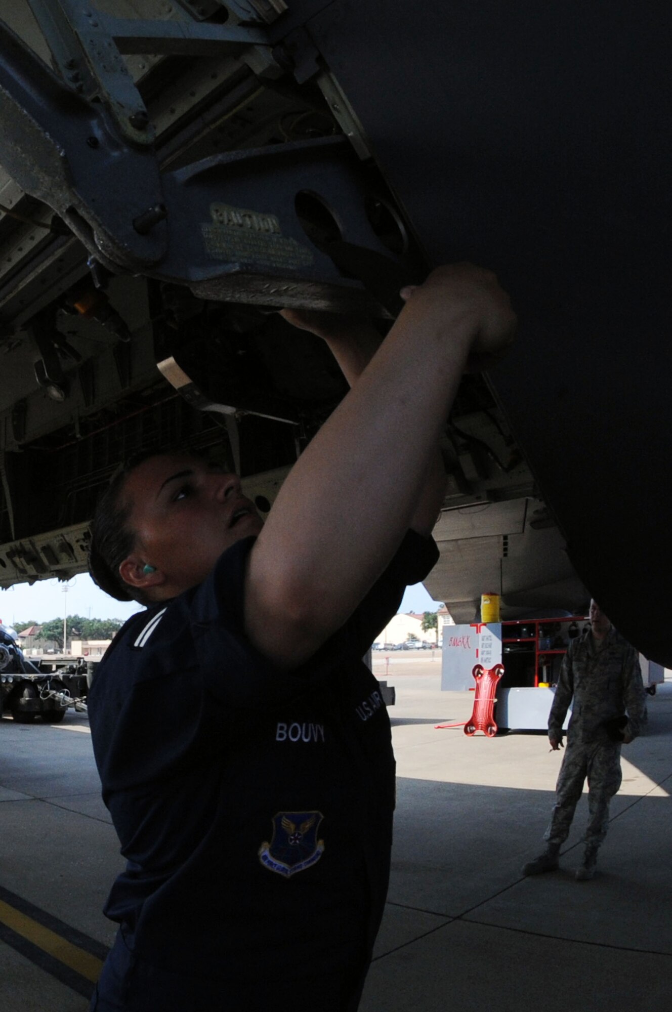 BARKSDALE AIR FORCE BASE, La. - Staff Sgt. Tahnee Bouvy, 2d Aircraft Maintenance Squadron weapons load crew member, follow the steps necessary to load trainer cruise missiles onto a B-52H Stratofortress during the Global Strike Challenge Aug. 17. The competition itself consisted of a test in knowledge of Air Force Instruction and technical data, dress and appearance, pre-flight inspection, trainer weapons loads and a buildup of munitions. (U.S. Air Force photo by Senior Airman Brittany Y. Bateman)(RELEASED)