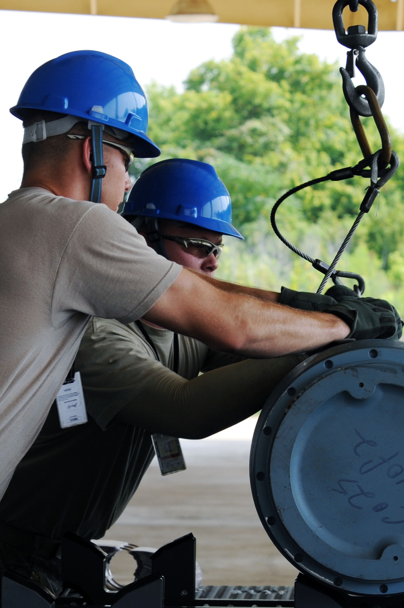 BARKSDALE AIR FORCE BASE, La. - Airmen from the 2d Munitions Squadron unhook a trainer weapon from a forklift during the Global Strike challenge Aug. 17. As many as 400 Airmen are competing, including Airmen from Air Force Global Strike Command, Air Combat Command and the Air Reserve Component. (U.S. Air Force photo by Senior Airman Brittany Y. Bateman)(RELEASED)