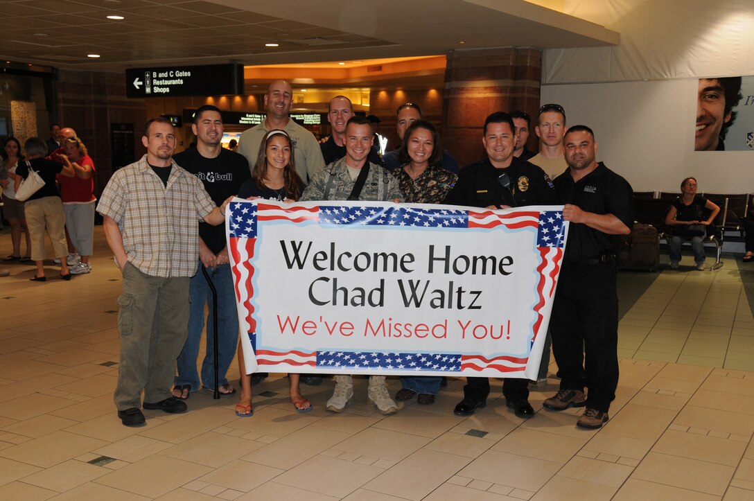 U.S. Air Force Staff Sgt. Chad Waltz, assigned to the 161st Air Refueling Wing Security Forces Squadron, Phoenix Ariz., is welcomed home by family and friends on Aug. 19, 2010 following a six month deployment to Kyrgyzstan in support of Operation Enduring Freedom. (U.S. Air Force photo by Master Sgt. Kelly Deitloff)
