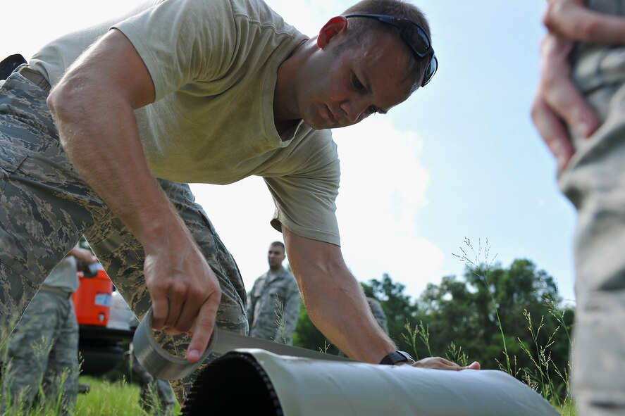 MOODY AIR FORCE BASE, Ga. -- Staff Sgt. Steve Harris, 23rd Civil Engineer Squadron Explosive Ordnance Disposal flight craftsman, places tape onto an explosive during training here Aug. 16. During the training, several different types of explosives were detonated to observe its effects on various items. (U.S. Air Force photo/Airman 1st Class Joshua Green)
