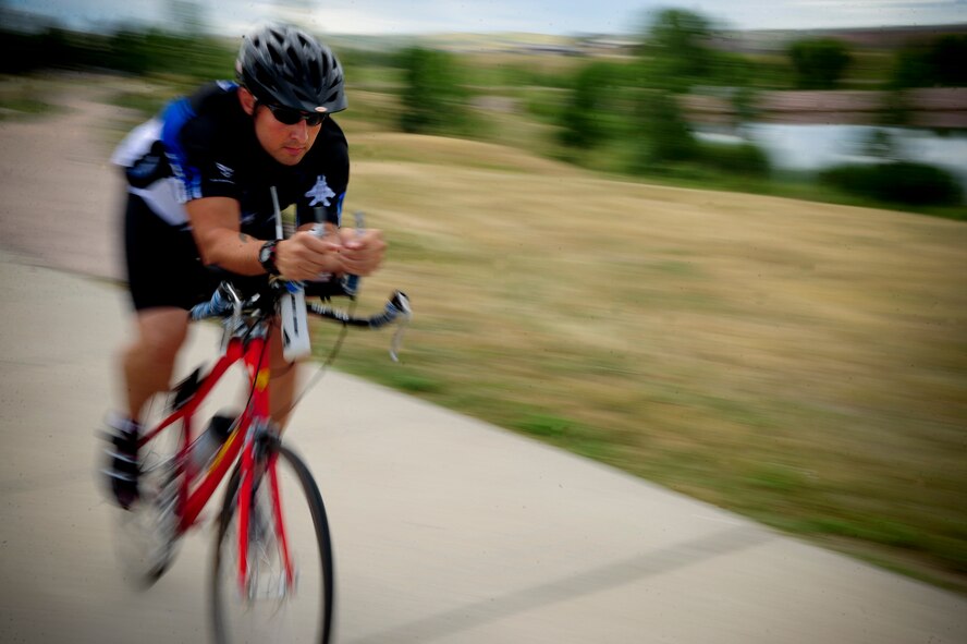 ELLSWORTH AIR FORCE BASE, S.D. – Tech. Sgt. Kory Lindsey, 28th Operations Support Squadron air traffic control journeyman, rides his bicycle, August 16. Sergeant Lindsey rides his bike as a cardio exercise to help stay fit.  (U.S. Air Force photo/Senior Airman Corey Hook)