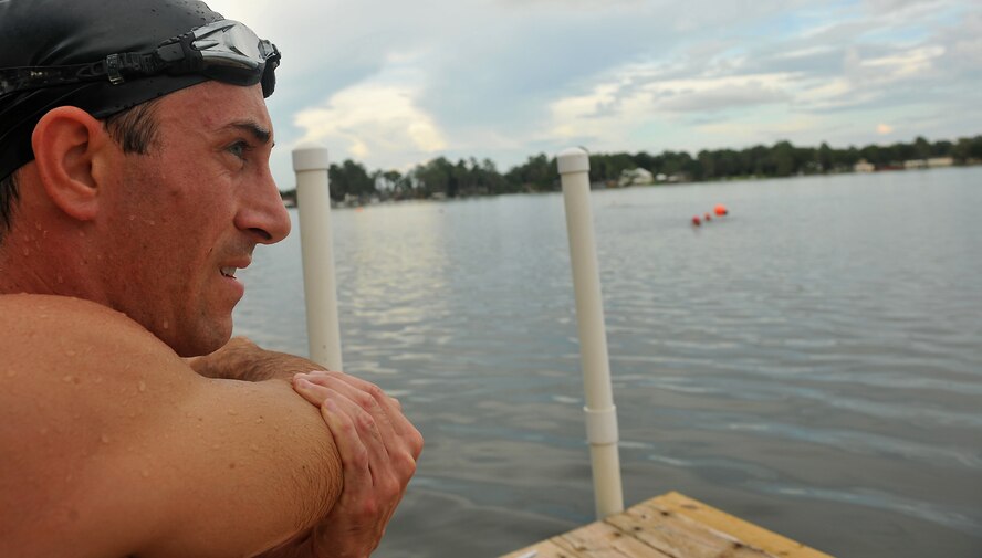 Lake Park, Ga. -- Capt. Trevor Ambron, 822nd Security Forces Squadron physician assistant from Moody Air Force Base, Ga., stretches his muscles before beginning a 500-meter swim here Aug. 18. Captain Ambron is preparing for an upcoming triathlon event. (U.S. Air Force photo/Airman 1st Class Joshua Green)