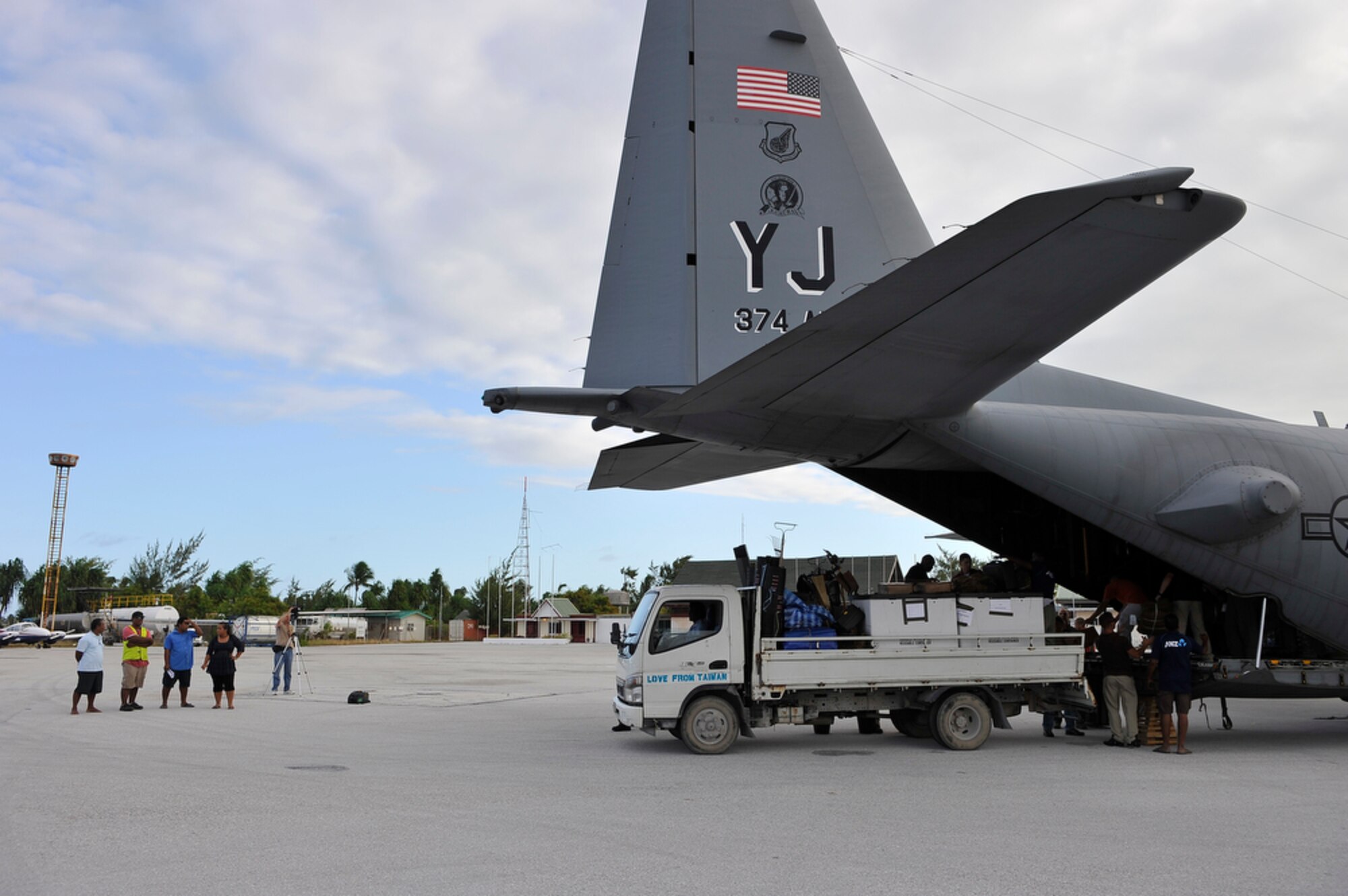 A C-130 Herules from the 374th Airlift Wing unloads people and supplies from the Joint POW/MIA Accounting Command after arriving in Tarawa, Republic of Kiribati, on Aug 6, 2010 to recover remains of Marines from the WWII Battle of Tarawa where a total of 6,000 men from U. S. and Japan lost their lives. (U.S.  Air Force photo/Tech Sgt. Cohen A. Young)