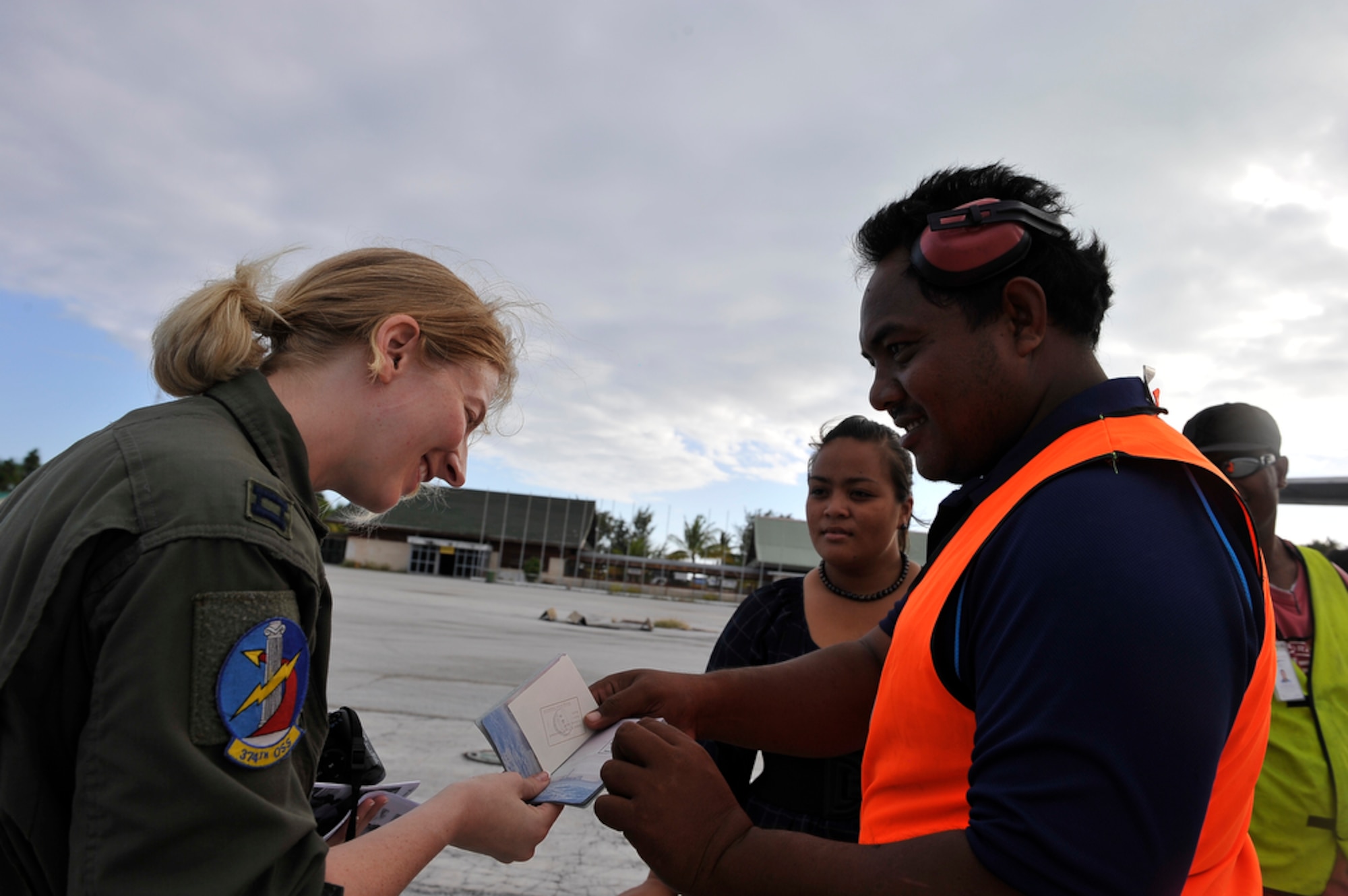374th Airlift Wing pilot, Captain Jaime Crossler gets her passport signed after delivering members of the Joint POW/MIA Accounting Command to Tarawa, Republic of Kiribati, on Aug 6, 2010 in an effort to recover remains of Marines from the WWII Battle of Tarawa where a total of 1,113 Marines from the 2nd Marine Division were killed and 2,290 were wounded. This is the first time that JPAC will be recovering remains from this battle. (U.S.  Air Force photo/Tech Sgt. Cohen A. Young)