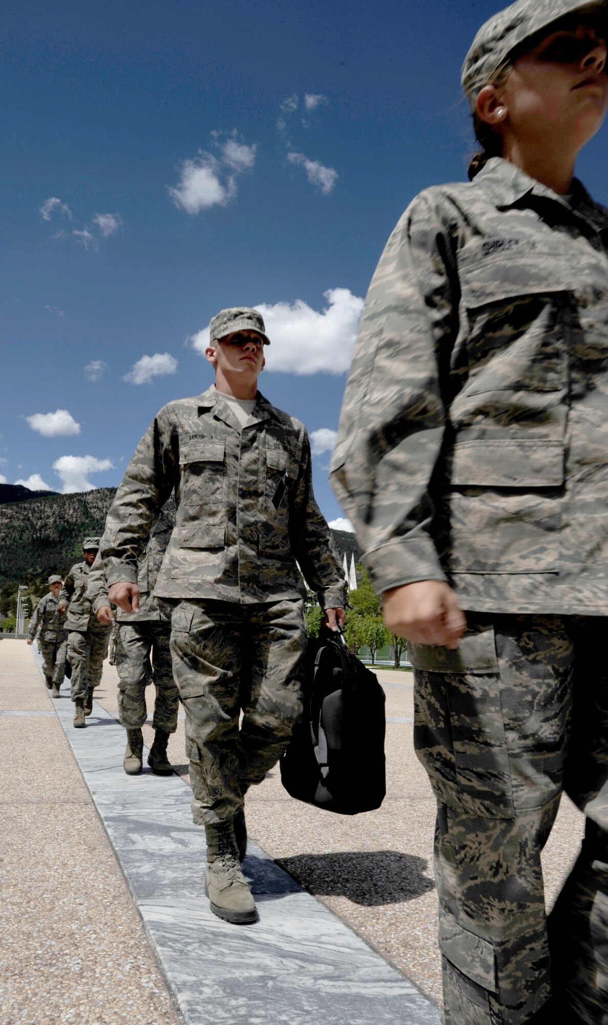 From right: Cadets 4th Class Paige Shirley and Michael Armour and other fourth-class cadets run the strips between classes while carrying their backpacks in their hands at the Air Force Academy Aug. 10, 2010. The Dean of Faculty plans to explore how replacing traditional textbooks with e-books might unencumber cadets. (U.S. Air Force photo/Johnny Wilson)