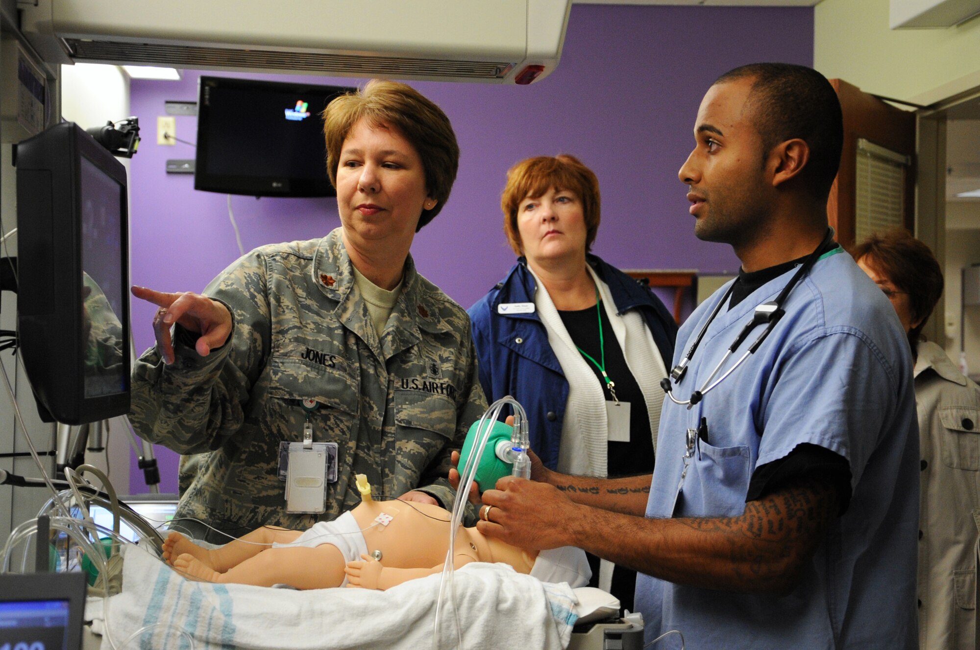 JOINT BASE ELMENDORF-RICHARDSON, Alaska -- Maj. Janet Jones and Staff Sgt. Jose Gonzalez simulate resuscitating a newborn baby during the Chief of Staff civic leader tour Aug.12. The tour was to provide U.S.-based Chief of Staff of the Air Force civic leaders an opportunity to experience firsthand the Alaska mission across the Joint Operating Area and provide an opportunity for interaction and networking among joint service members and civic leaders. Major Jones is the element leader for the perinatal services unit/labor and delivery unit and Sergeant Gonzalez is an aerospace medical technician both with the 673d Medical Group. (Air Force photo by Senior Airman Cynthia Spalding) 