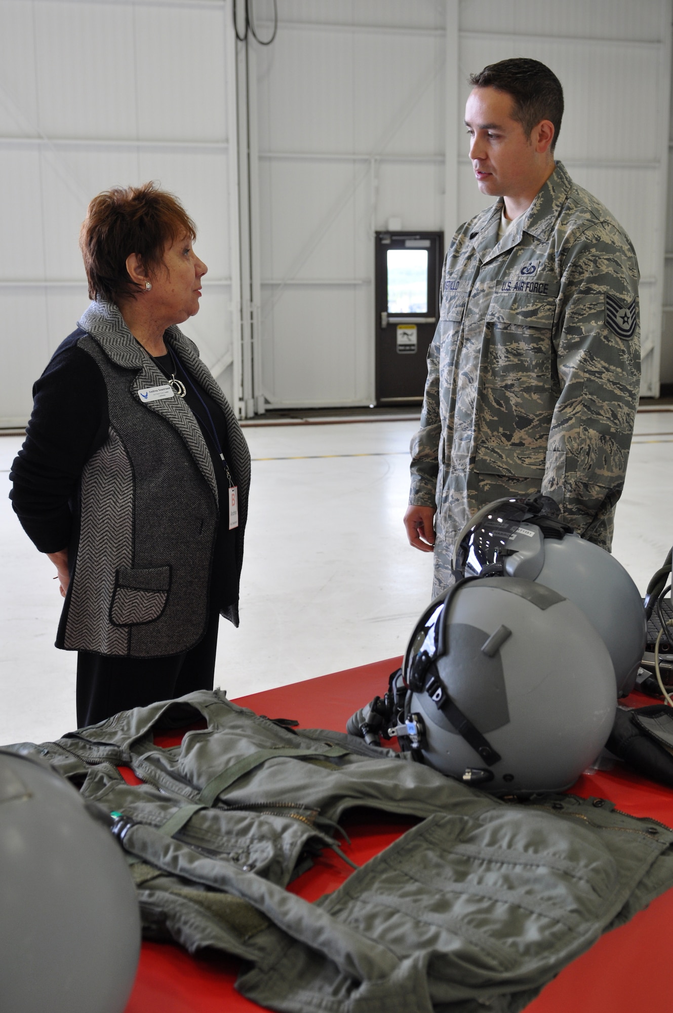 JOINT BASE ELMENDORF-RICHARDSON, Alaska -- Tech. Sgt. Ramiro Castillo talks about the different pieces of aircrew flight gear with a civic leader during the Chief of Staff civic leader tour Aug. 9. The tour was to provide U.S.-based Chief of Staff of the Air Force civic leaders an opportunity to experience firsthand the Alaska mission across the Joint Operating Area and provide an opportunity for interaction and networking among joint service members and civic leaders. Sergeant Castillo is the noncommissioned officer in charge of the 19th Fighter Squadron aircrew flight equipment. (Air Force photo by Senior Airman Cynthia Spalding) 