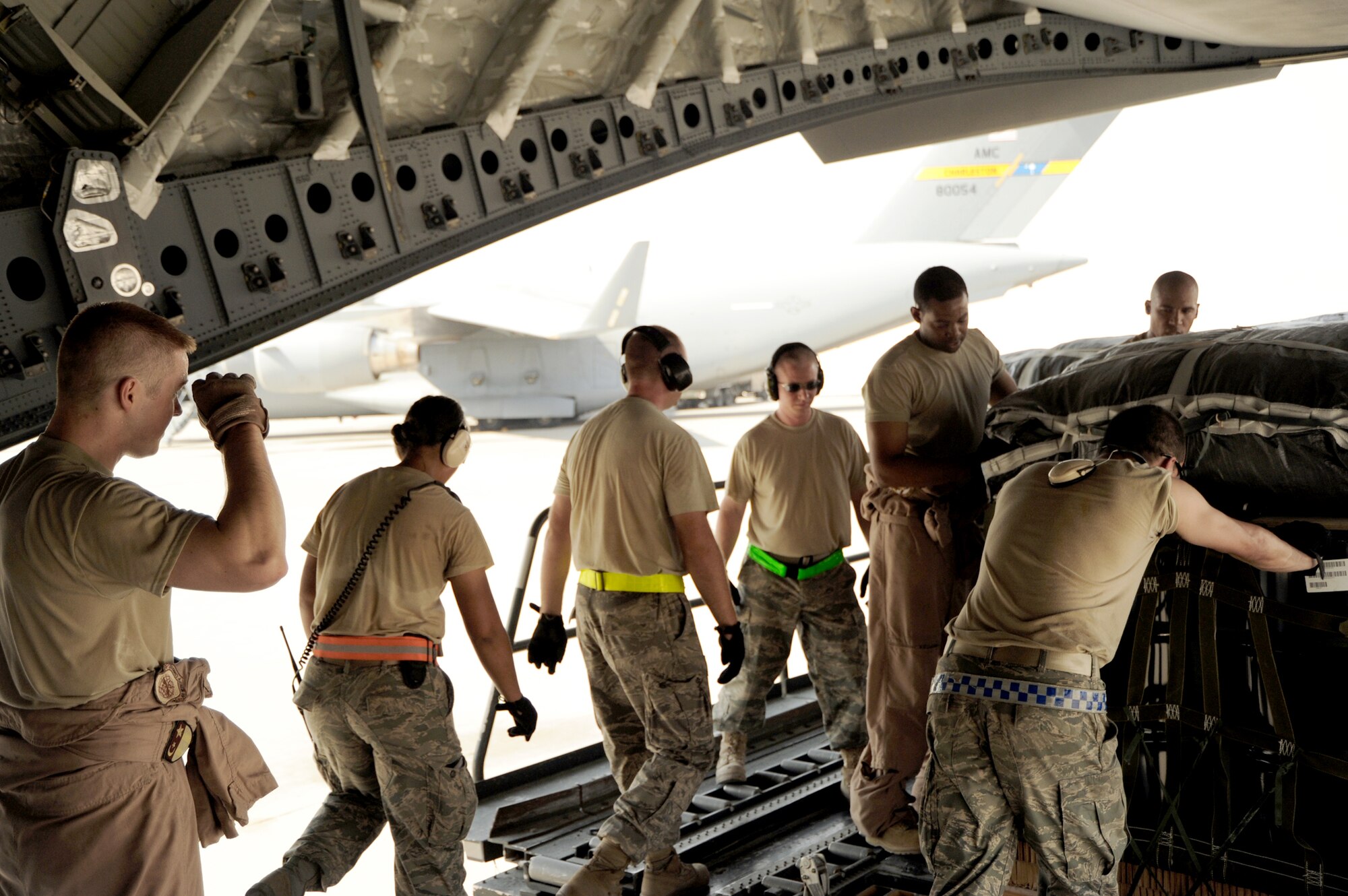 Airmen pull bundles of JP-8 fuel onto a C-17 Globemaster III before an airdrop mission Aug. 13, 2010, at an air base in Southwest Asia.  The drop was part of Operation Everest, a week-long effort delivering 837 of bundles of supplies and equipment to forward operating bases across the area of responsibility. (U.S. Air Force photo/Staff Sgt. Tim Jenkins)