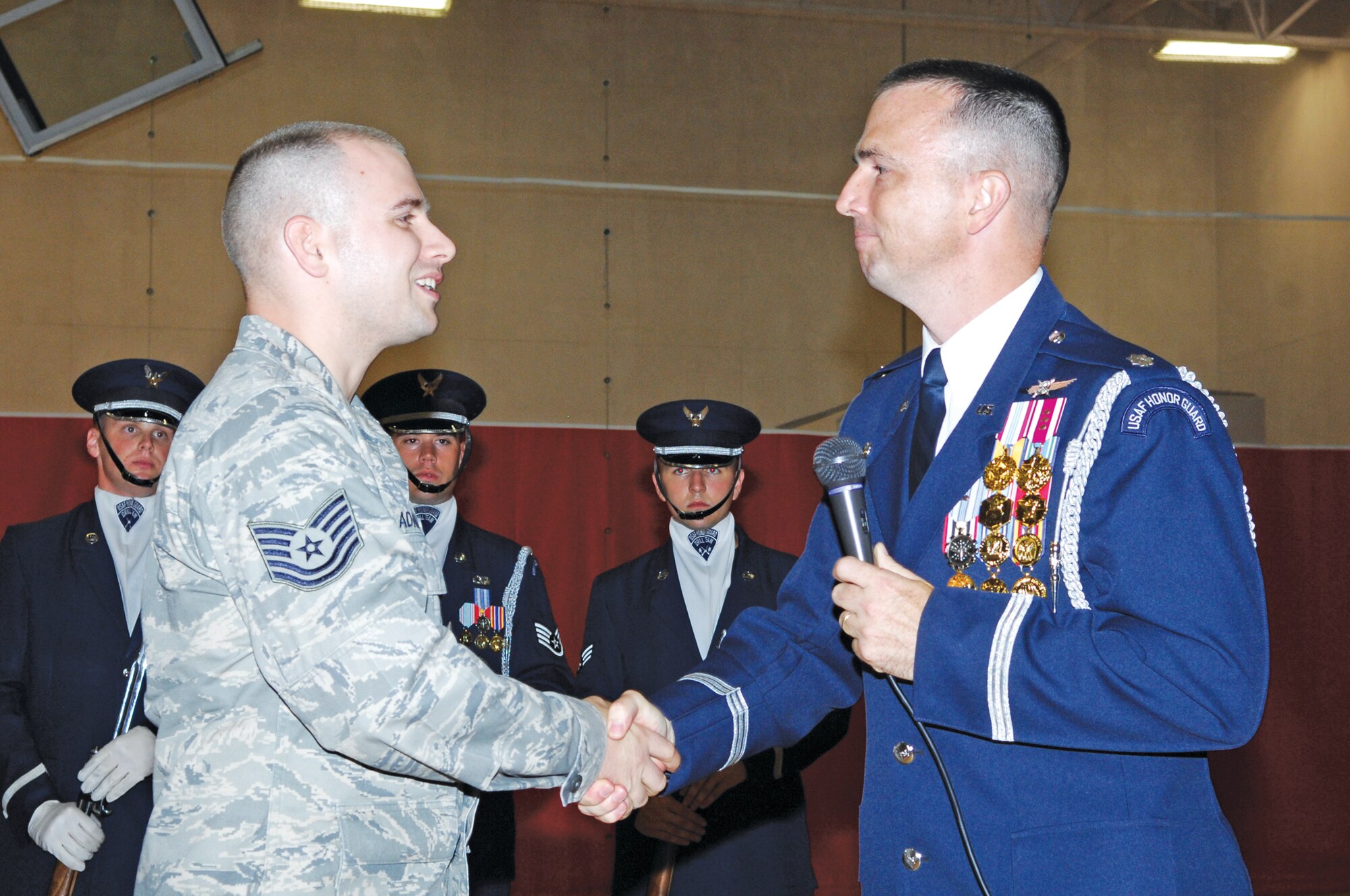 Tech. Sgt. Mark Adams, 56th Component Maintenance Squadron, shakes hands
with Lt. Col. Raymond Powell, U.S. Air Force Honor Guard commander, Aug. 10
when the two met in person for the first time when the U.S. Air Force Honor
Guard Drill Team visited Luke Air Force Base.  (U.S. Air Force photo/Staff Sgt. Steven Nabor)
