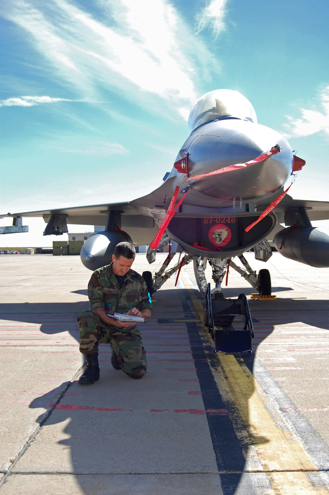 Master Sgt. Evan Finn performs maintenance actions on an F-16.  Fenn was selected as the Thomas N. Barnes Award winner recently making him the best crew chief in the Air National Guard.