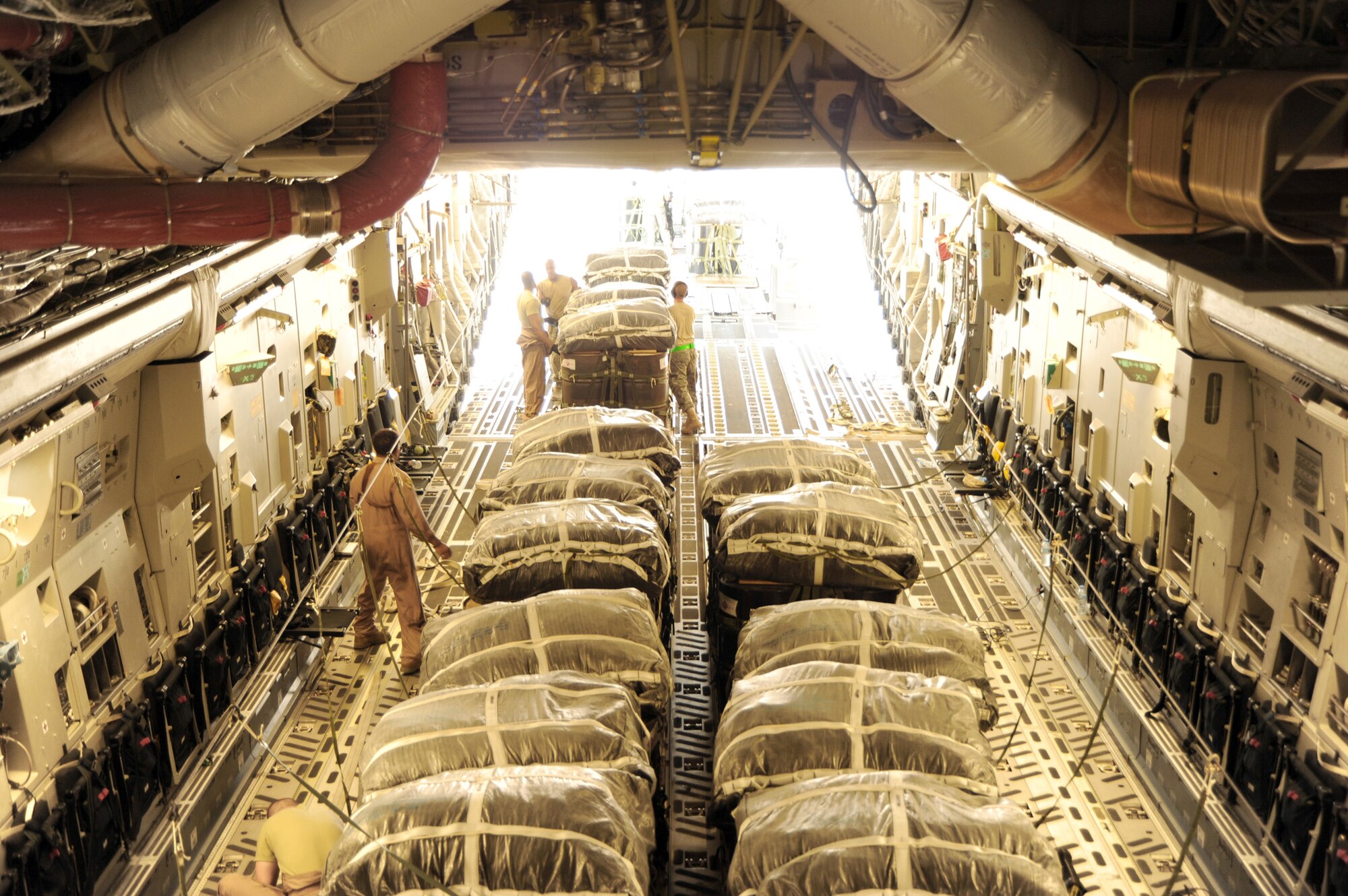 Airmen load bundles onto a C-17 Globemaster III prior to an airdrop mission Aug. 13, 2010, in Southwest Asia. (U.S. Air Force photo/Staff Sgt. Tim Jenkins)