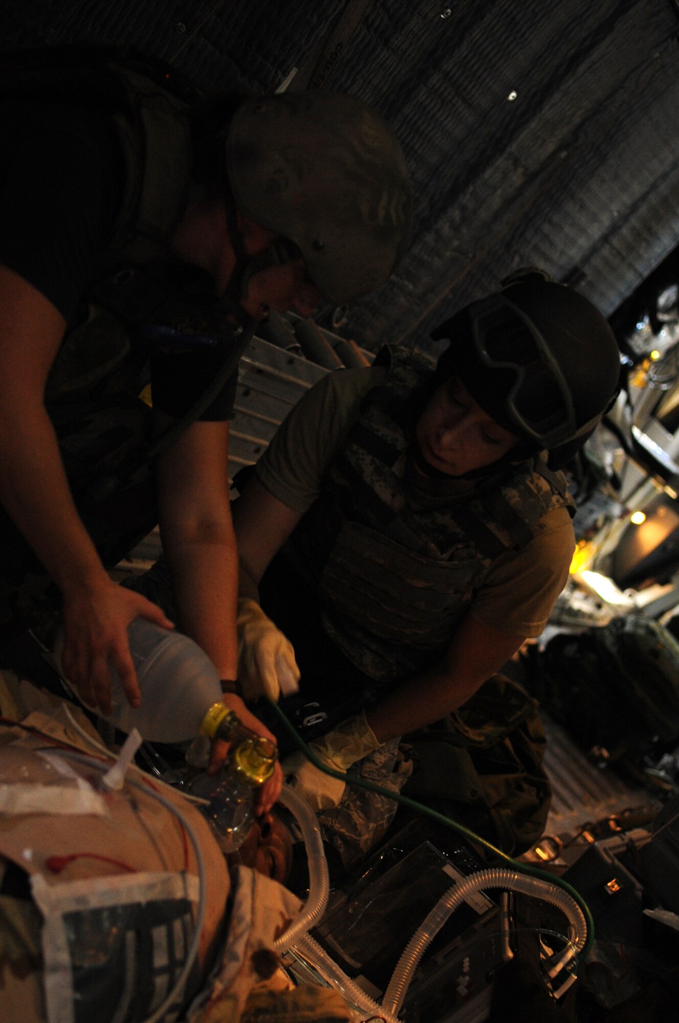 Staff Sgt. Nicole Spickerman(left), 1st Special Operations Support Squadron independent duty medical technician and Casualty Evacuation course student and Capt. Olivia Jackson (right), registered nurse and CASEVAC student from Travis Air Force Base, Calif., assess a simulated patient onboard an MC-130 assigned to the 6th Special Operations Squadron Aug. 9. The two week CASEVAC course, conducted by the Tactical Operations Medical Skills Center, trains special operations medical forces to retrieve, treat and transport wounded servicemembers through any means possible. (DoD photo by Air Force Airman Caitlin O'Neil-McKeown)