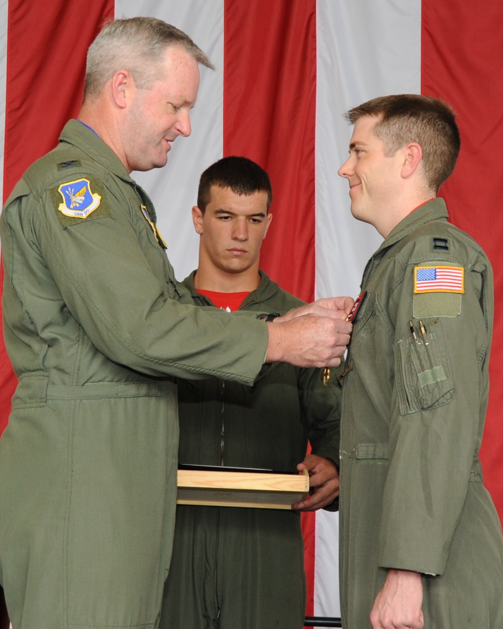 Colonel Scott Smith, 305th Air Mobility Wing commander, presents Capt. Mason MacGarvey, a KC-10 Extender pilot with the 2nd Air Refueling Squadron, with the Distinguished Flying Cross during a ceremony here Aug. 6. While deployed to Iraq in 2008, MacGarvey safely landed a C-130 with three of the four engines inoperable, saving the lives of the 38 people on board. (U.S. Air Force photo/Airman 1st Class Bryan Swink)