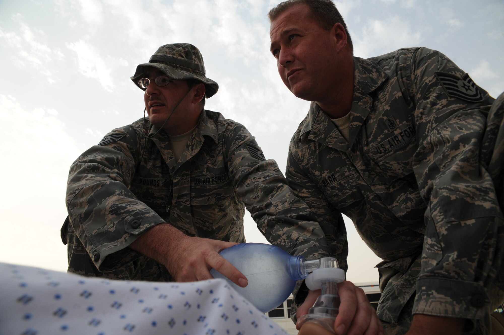 Technical Sergeant James Pounds and Technical Sergeant Donald Barr stabilizes a trauma patient for training at an undisclosed location in Southwest Asia July 28. Sergeant Barr and Sergeant Pounds are aerospace medical technicians with the 379th Expeditionary Medical Operations flight and are deployed from Keesler AFB, Miss. (U.S. Air Force photo/Senior Airman Katie Gieratz)  