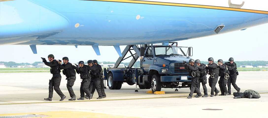 Members of the 316th Security Forces Squadron emergency services team prepare to enter a hijacked aircraft during an exercise at Joint Base Andrews, Md. 17 Aug 2010. EST is made up security forces members with special tactics training who are called out for critical situations.  (U.S. Air Force photo by Senior Airman Melissa V. Brownstein)