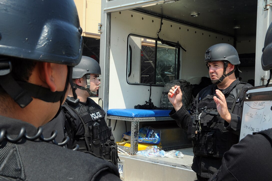 Technical Sgt. Eric Smith, 316th Security Forces Squadron emergency service team leader and military work dog trainer, briefs his team on an exercise hostage situation at Joint Base Andrews, Md. 17 Aug 2010. EST is made up security forces members with special tactics training who are called out for critical situations.  (U.S. Air Force photo by Senior Airman Melissa V. Brownstein)