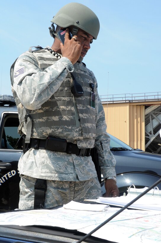 Technical Sgt. Sylvester Richburg, 316th Security Forces Squadron flight chief, coordinates operations during an aircraft hijacking exercise at Joint Base Andrews, Md. 17 Aug 2010. The 89th Air Wing and 316th SFS worked together to conduct the hostage negotiations. (U.S. Air Force photo by Senior Airman Melissa V. Brownstein)