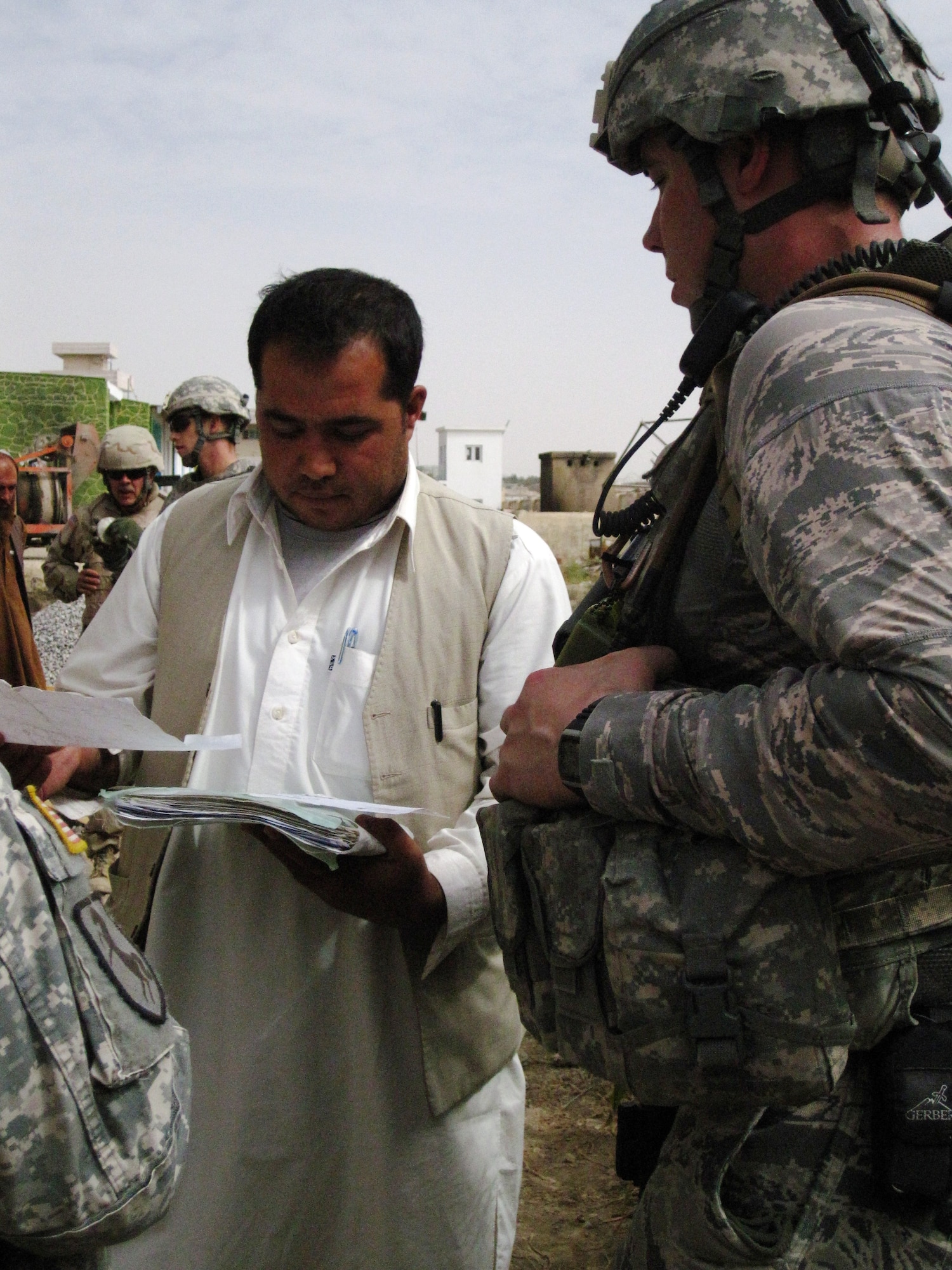 QALAT CITY, Afghanistan - Capt. Matthew Joseph, Provincial Reconstruction Team Zabul engineer and White Bear Lake, Minn. native, speaks with a contractor about construction at the Zabul Provincial Hospital in Qalat City, Aug. 17. PRT Zabul assists with the development and engineering of various reconstruction projects throughout the province. (U.S. Air Force photo/First Lt. Georganne Hassell/Released)