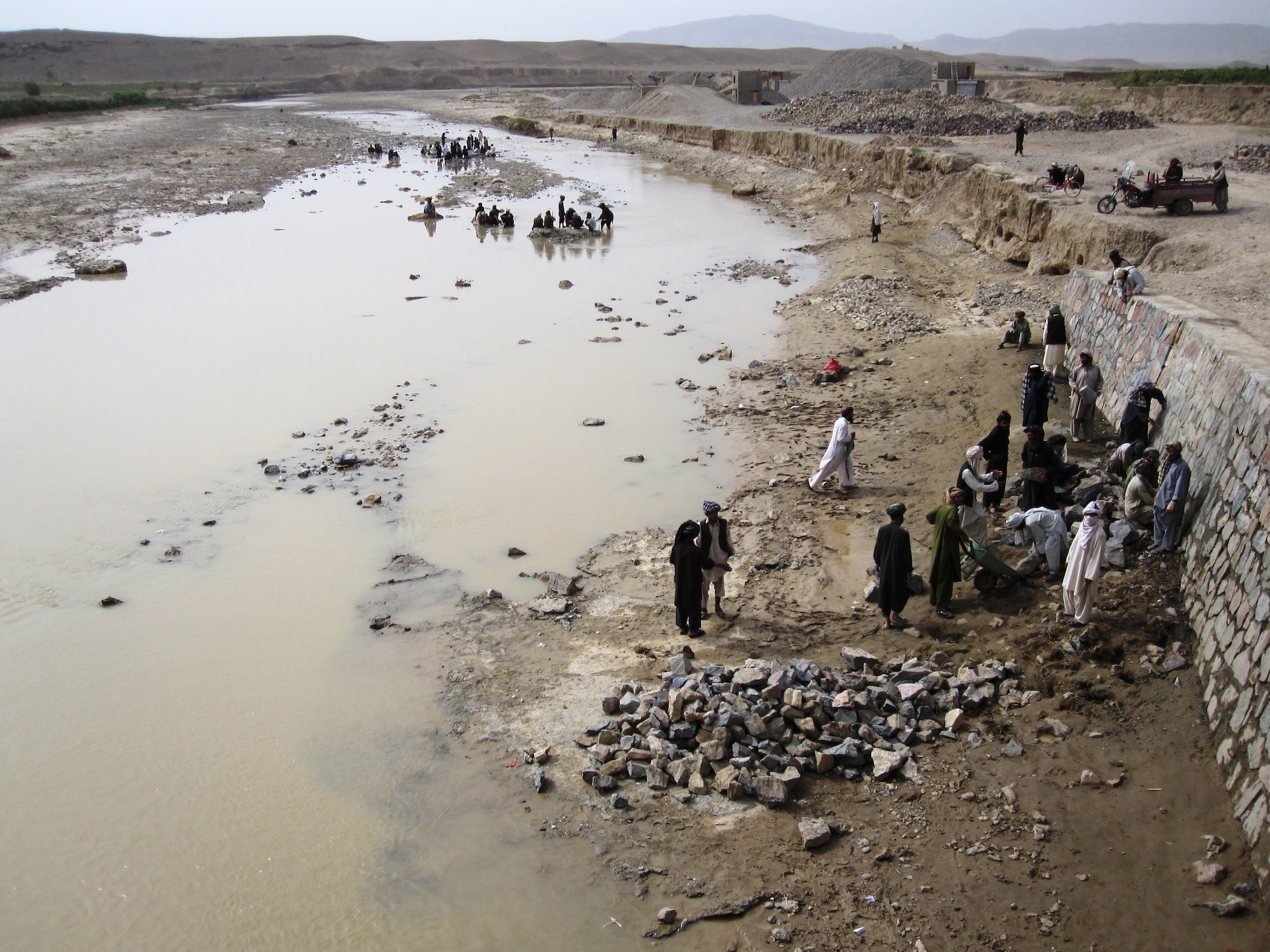 QALAT CITY, Afghanistan - Local Afghan men work on reconstructing the Tarnak Bridge in Qalat City, Zabul province, Aug. 17. More than 450 locals are employed for the reconstruction project which is sponsored by Provincial Reconstruction Team Zabul and the Government of the Islamic Republic of Afghanistan. (U.S. Air Force photo/First Lt. Georganne Hassell/Released)