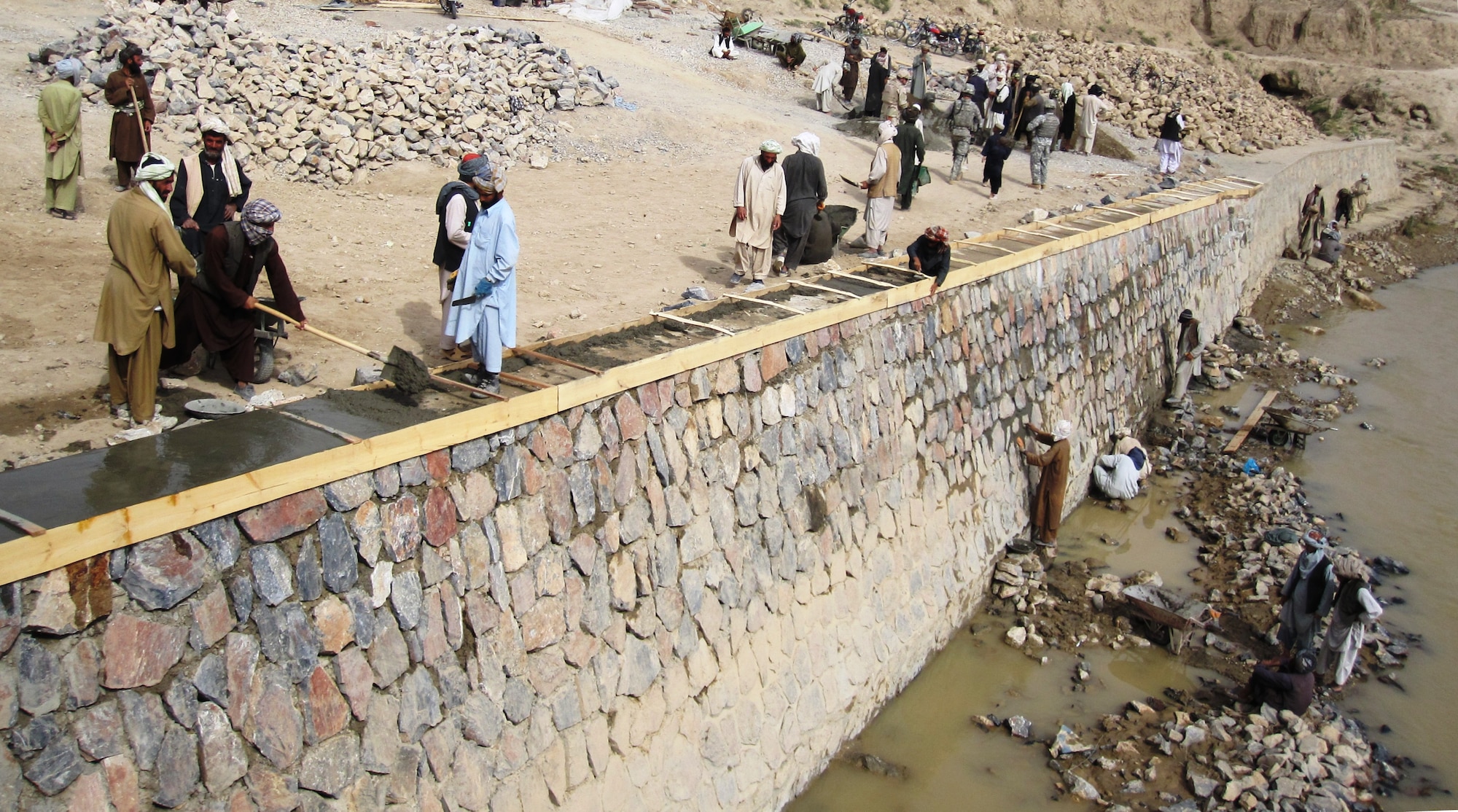 QALAT CITY, Afghanistan - Local Afghan men work on reconstructing the Tarnak Bridge in Qalat City, Zabul province, Aug. 17. More than 450 locals are employed for the reconstruction project which is sponsored by Provincial Reconstruction Team Zabul and the Government of the Islamic Republic of Afghanistan. (U.S. Air Force photo/First Lt. Georganne Hassell/Released)