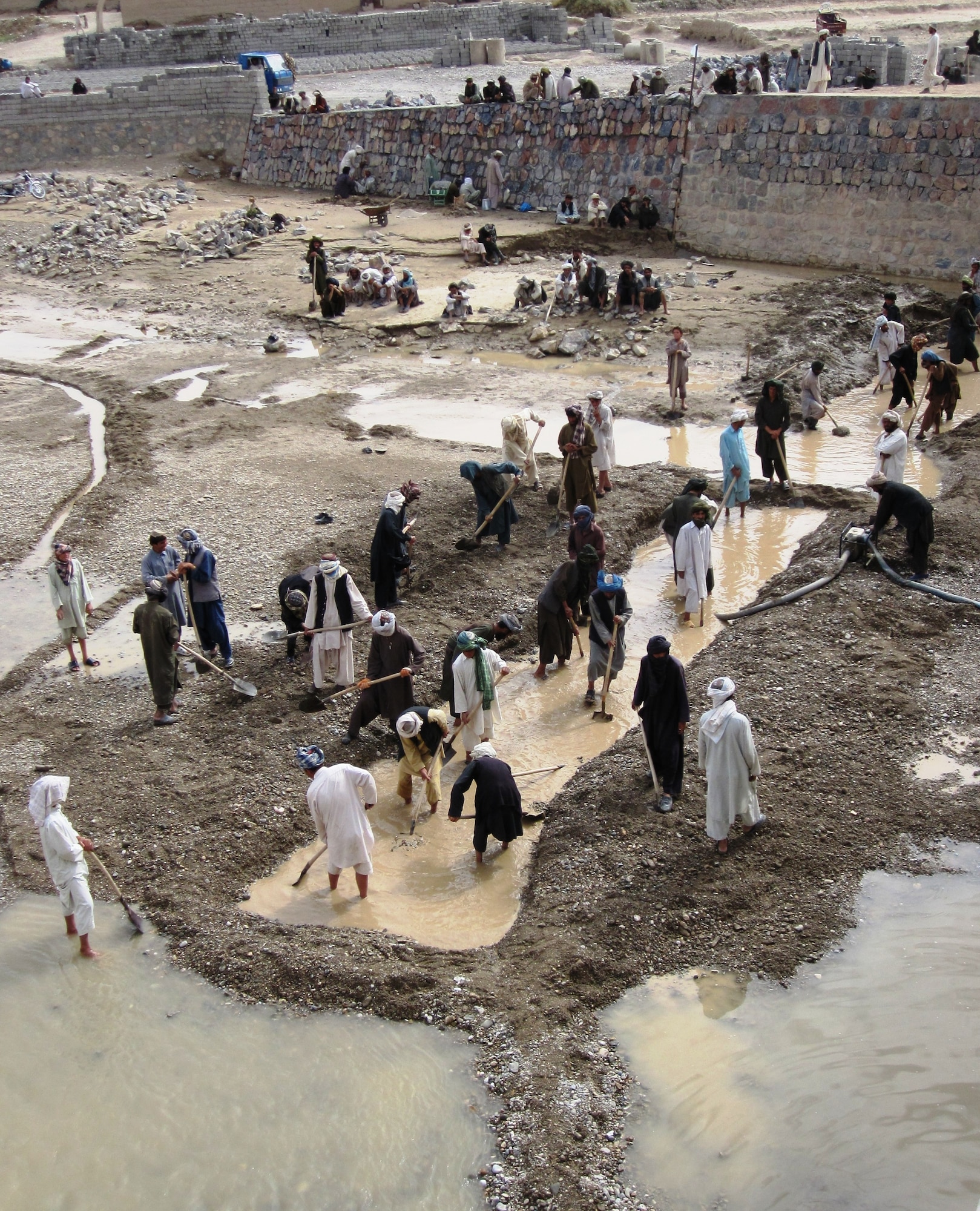 QALAT CITY, Afghanistan - Local Afghan men work on reconstructing the Tarnak Bridge in Qalat City, Zabul province, Aug. 17. More than 450 locals are employed for the reconstruction project which is sponsored by Provincial Reconstruction Team Zabul and the Government of the Islamic Republic of Afghanistan. (U.S. Air Force photo/First Lt. Georganne Hassell/Released)